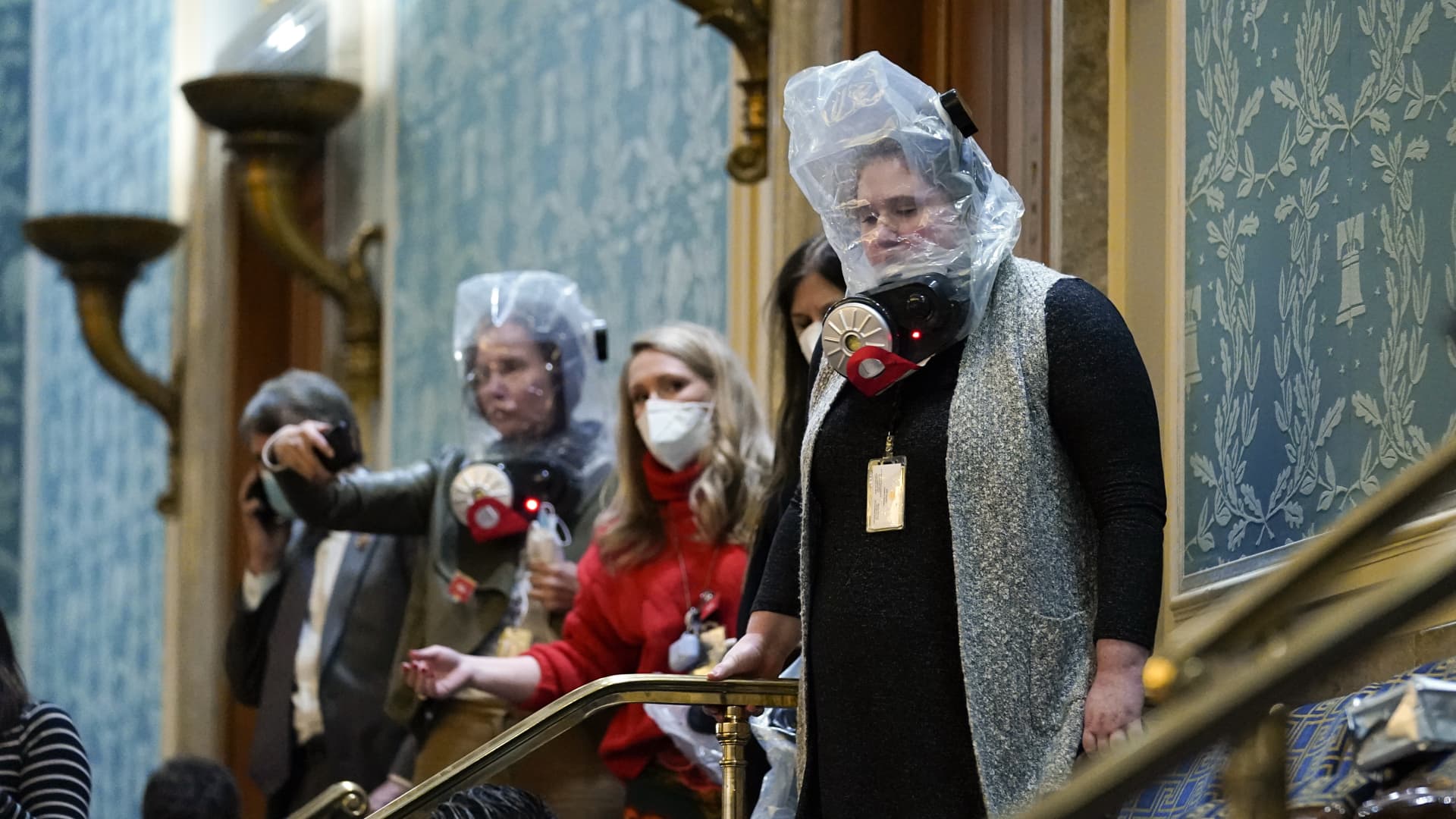 People are seen in the House gallery as protesters try to break into the House Chamber at the U.S. Capitol on Wednesday, Jan. 6, 2021, in Washington.
