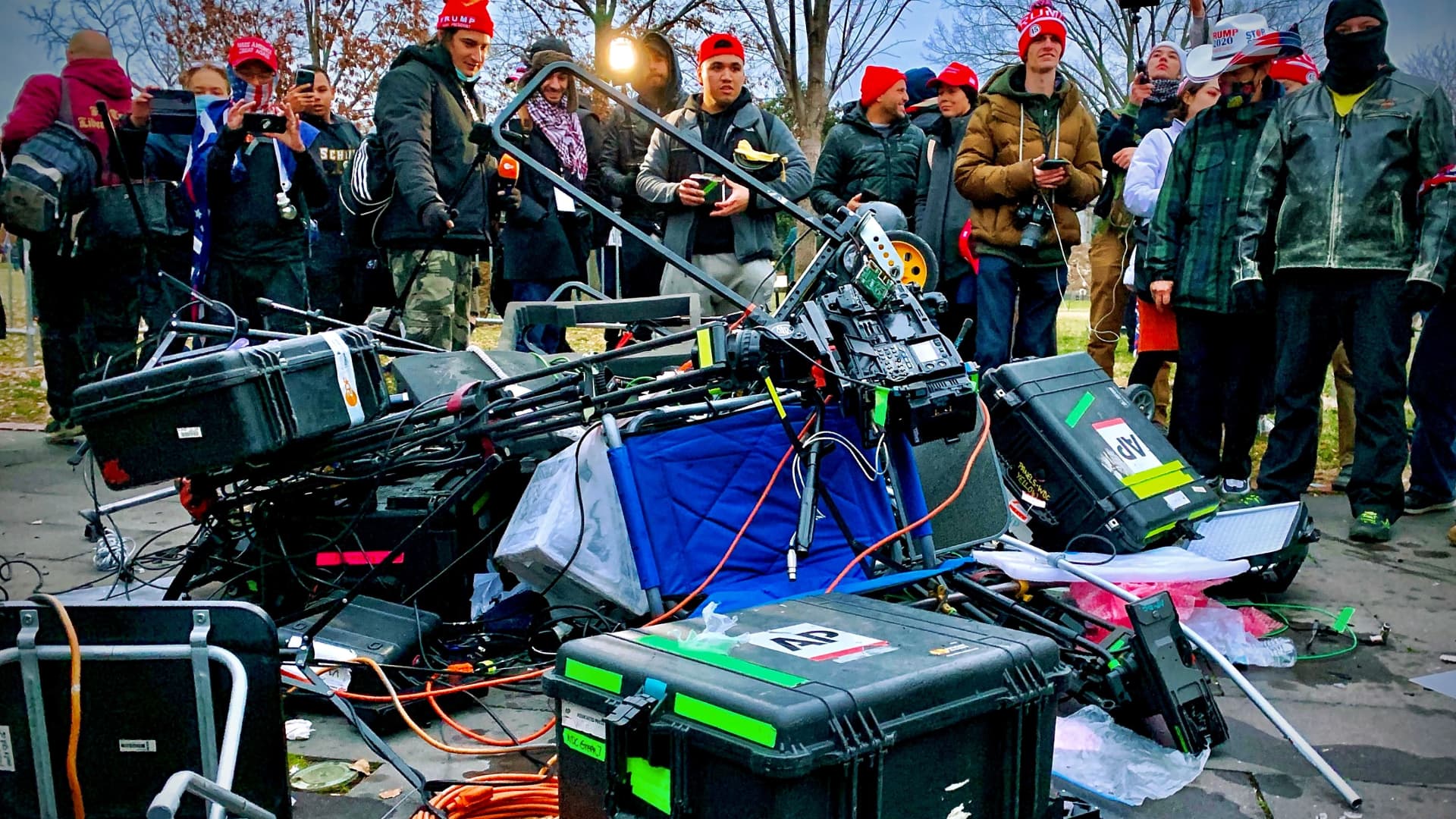 Supporters of US President Donald Trump stand next to media equipment they destroyed during a protest on JAnuary 6, 2020 outside the Capitol in Washington, DC.
