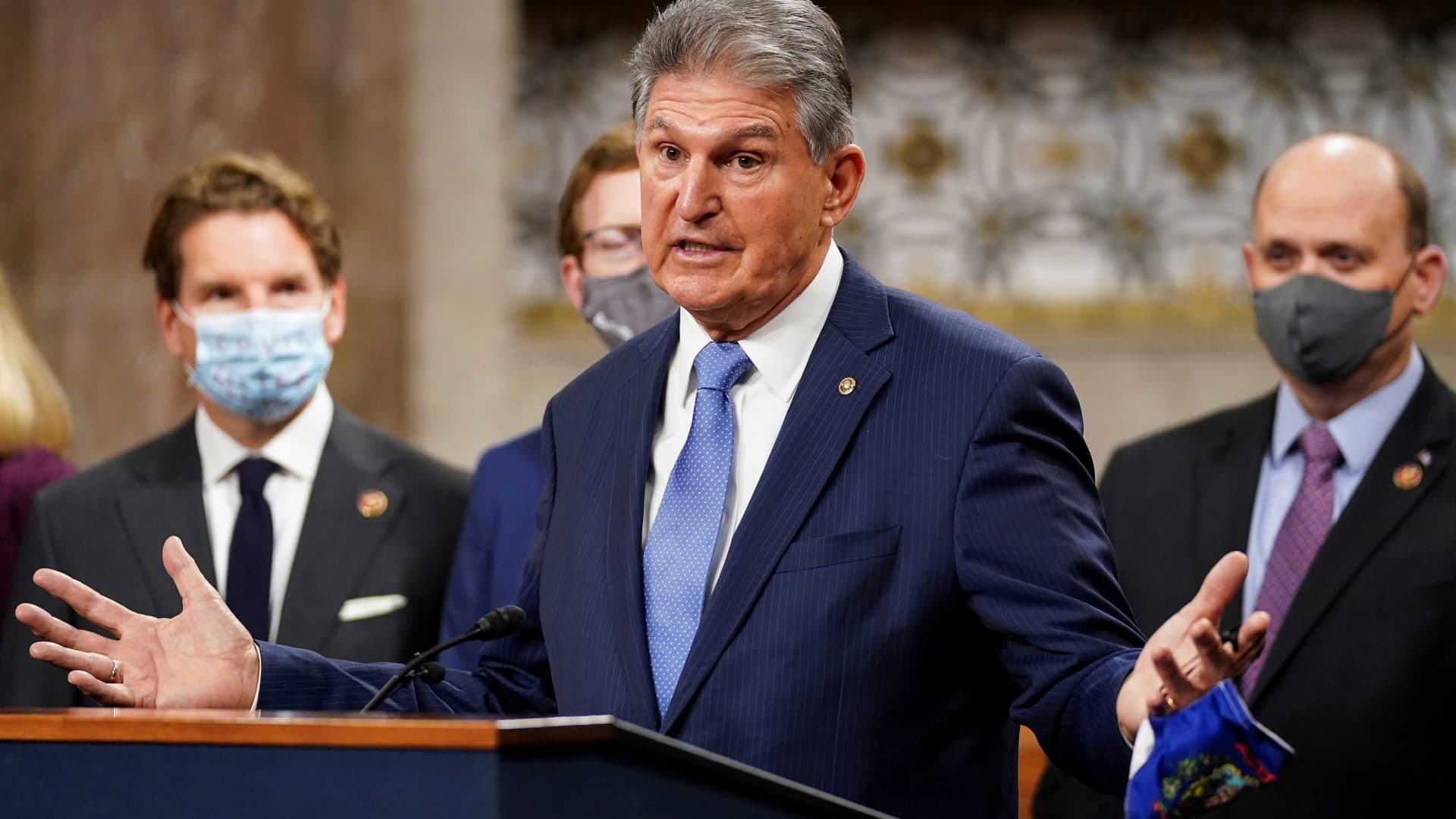 Senator Joe Manchin (D-WVA) removes his mask to speak as bipartisan members of the Senate and House gather to announce a framework for fresh coronavirus disease (COVID-19) relief legislation at a news conference on Capitol Hill in Washington, December 1, 2020.