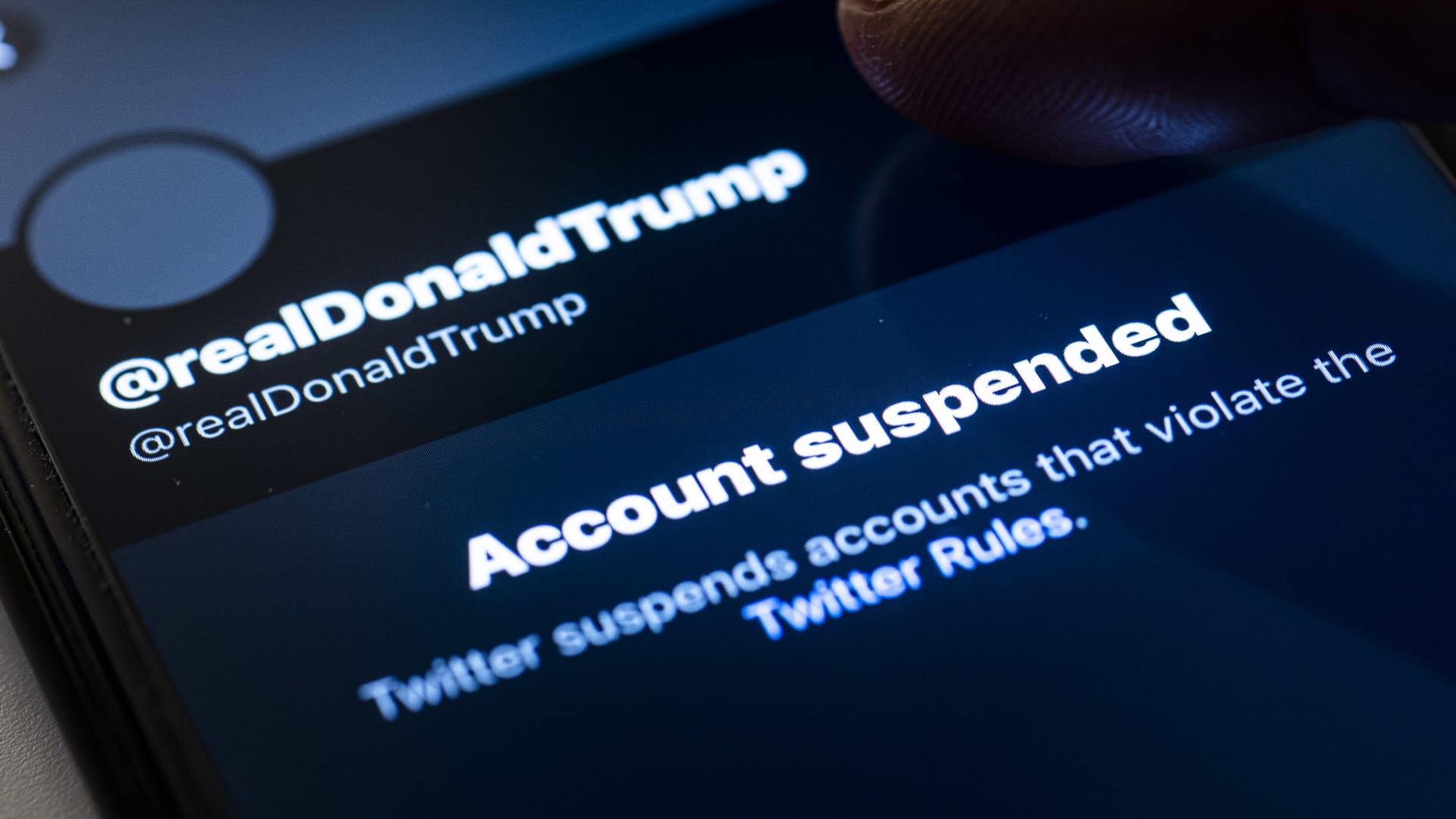 A person tabs on the suspended account of Donald Trump, President of the United States of America, on Twitter on January 09, 2021.