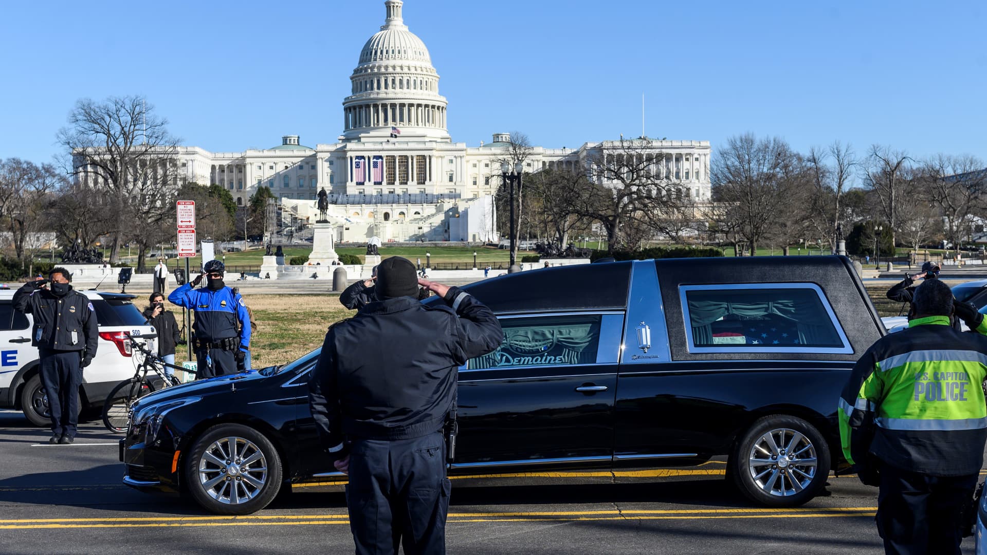 US Capital police stand at attention as the casket with fallen police officer, Brian Sicknick, passes during a funeral procession in Washington, DC on January 10, 2021.