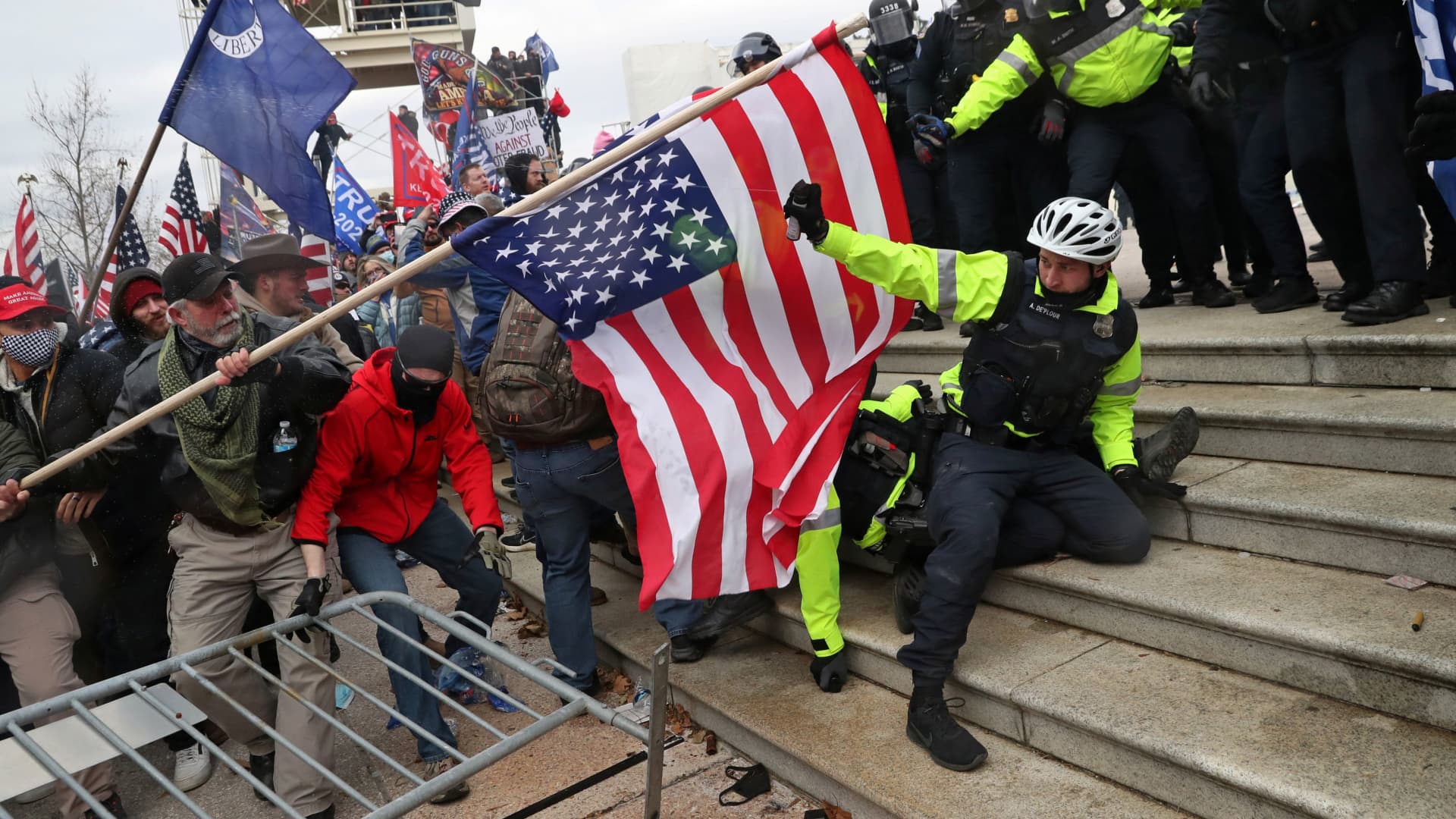 Members of U.S. Capitol Police try to fend off a mob of supporters of U.S. President Donald Trump as one of them tries to use a flag like a spear as the supporters storm the U.S. Capitol Building in Washington, January 6, 2021.