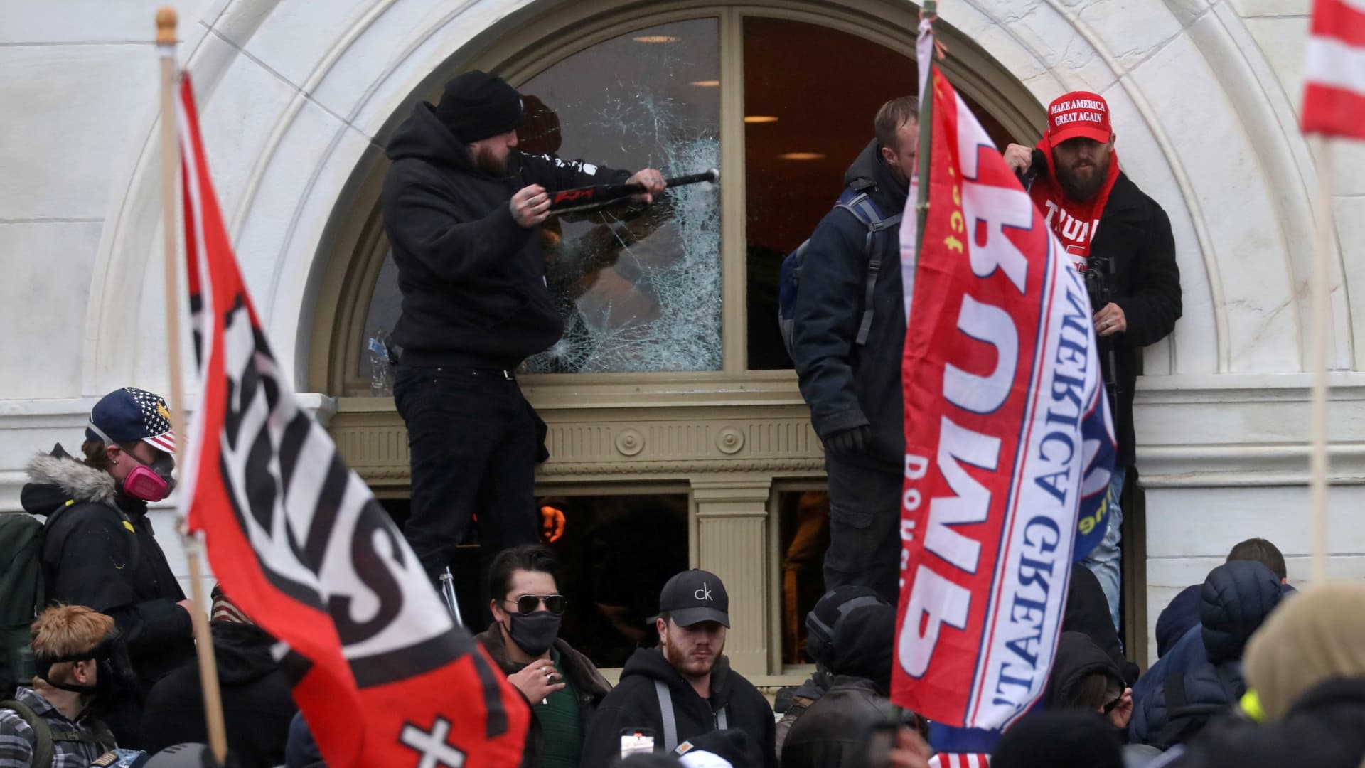 A man breaks a window as a mob of supporters of U.S. President Donald Trump storm the U.S. Capitol Building in Washington, U.S., January 6, 2021.