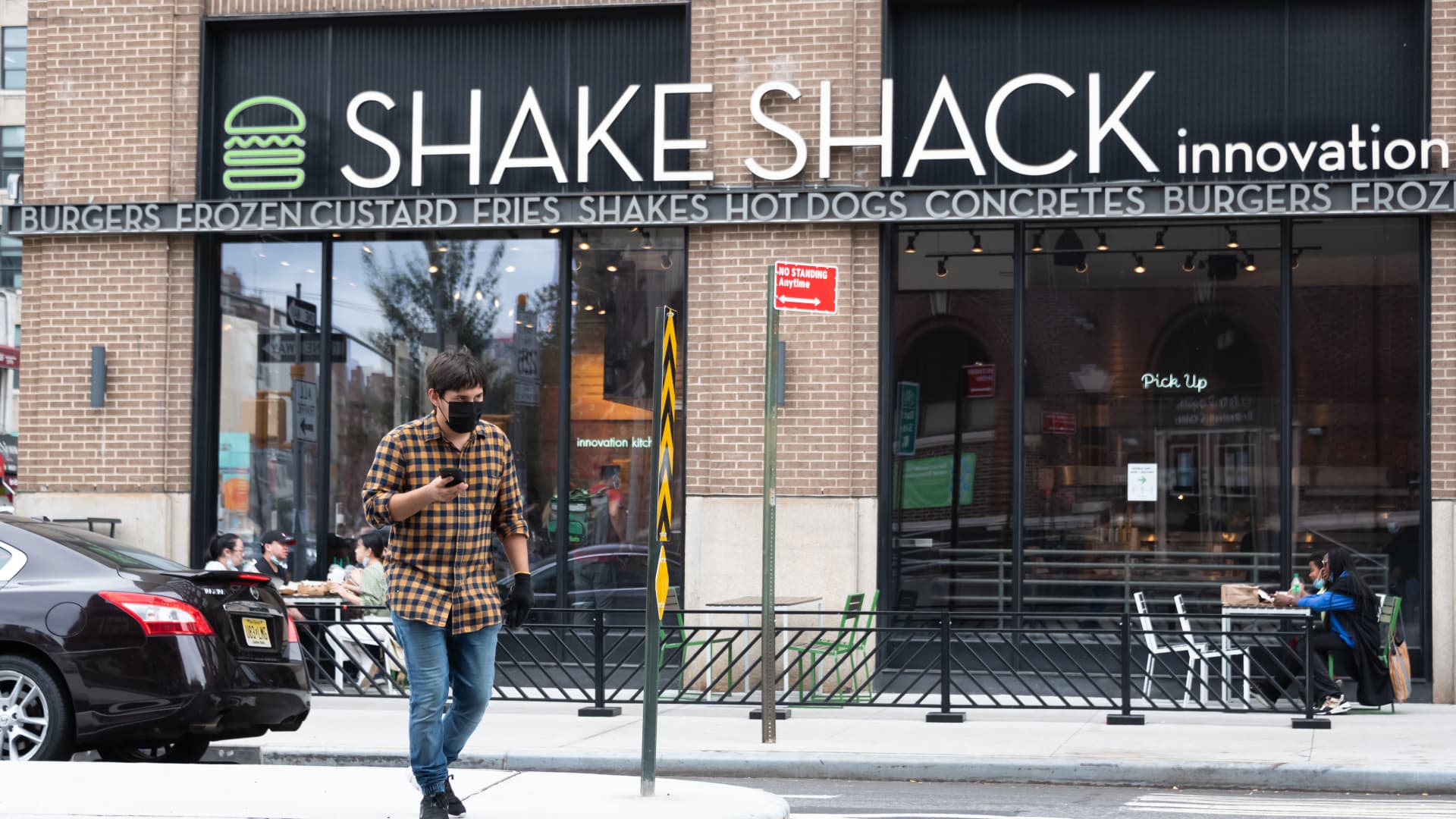 A person wears a face mask outside Shake Shack Innovation Kitchen in Greenwich Village as the city continues Phase 4 of re-opening following restrictions imposed to slow the spread of coronavirus on September 27, 2020 in New York City.