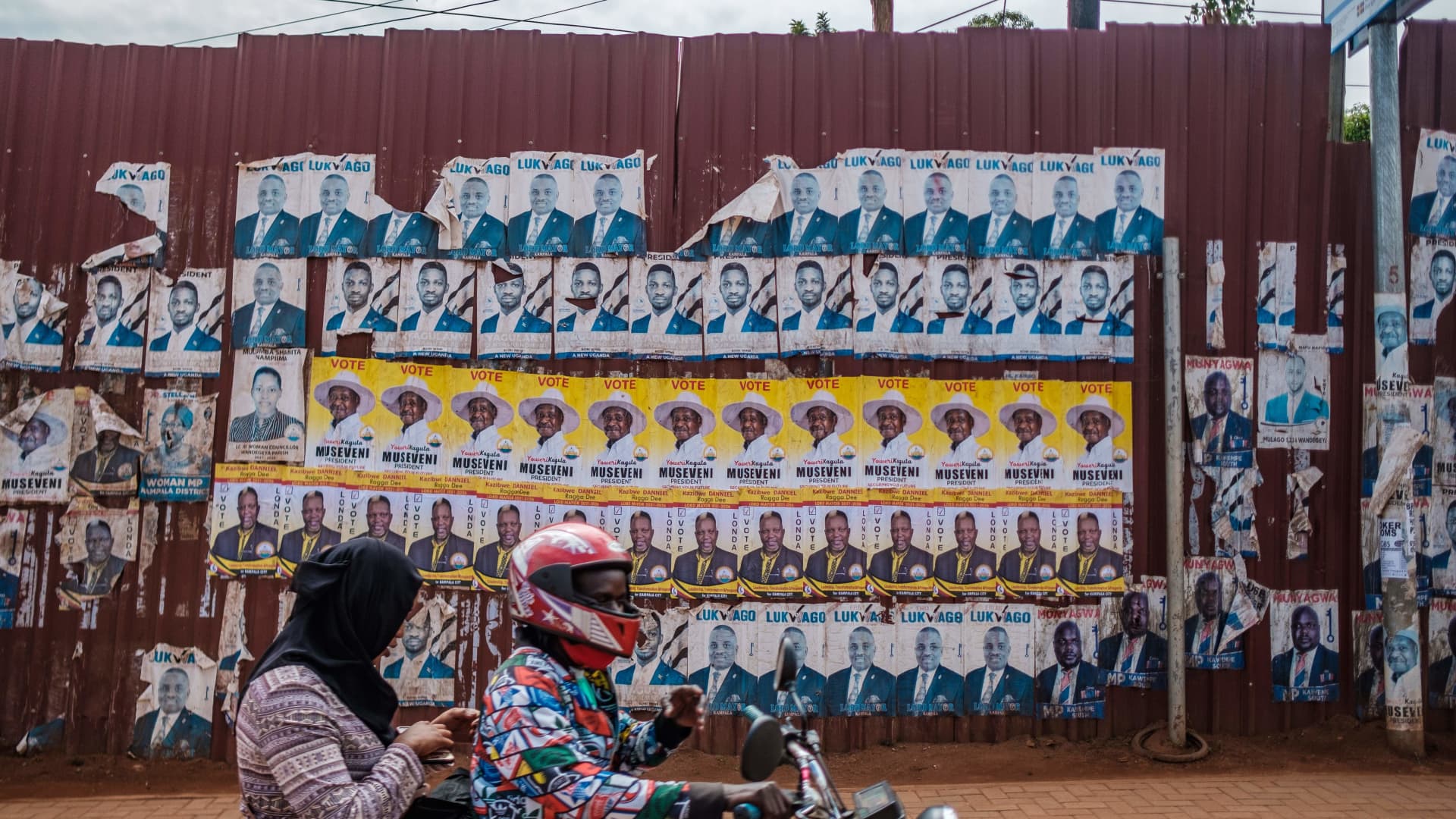 Posters of the two most popular candidates for Uganda's Presidential election, incumbent President Yoweri Museveni (yellow) and Robert Kyagulanyi, aka Bobi Wine, the pop star-turned-opposition leader, are seen along a street in Kampala, Uganda, on January 6, 2021.
