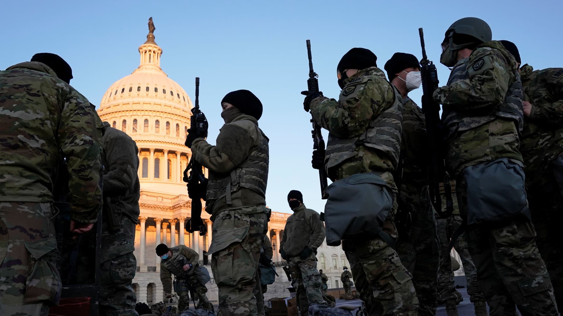 Members of the National Guard are given weapons before Democrats begin debating one article of impeachment against U.S. President Donald Trump at the U.S. Capitol, in Washington, U.S., January 13, 2021.