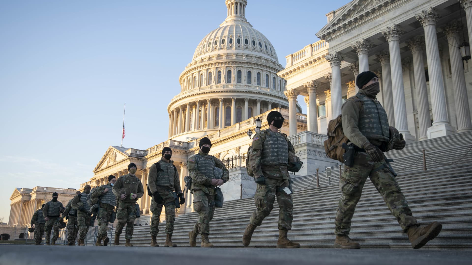 Members of the National Guard walk outside of the U.S. Capitol building in Washington, D.C., U.S., on Wednesday, Jan. 13, 2021.