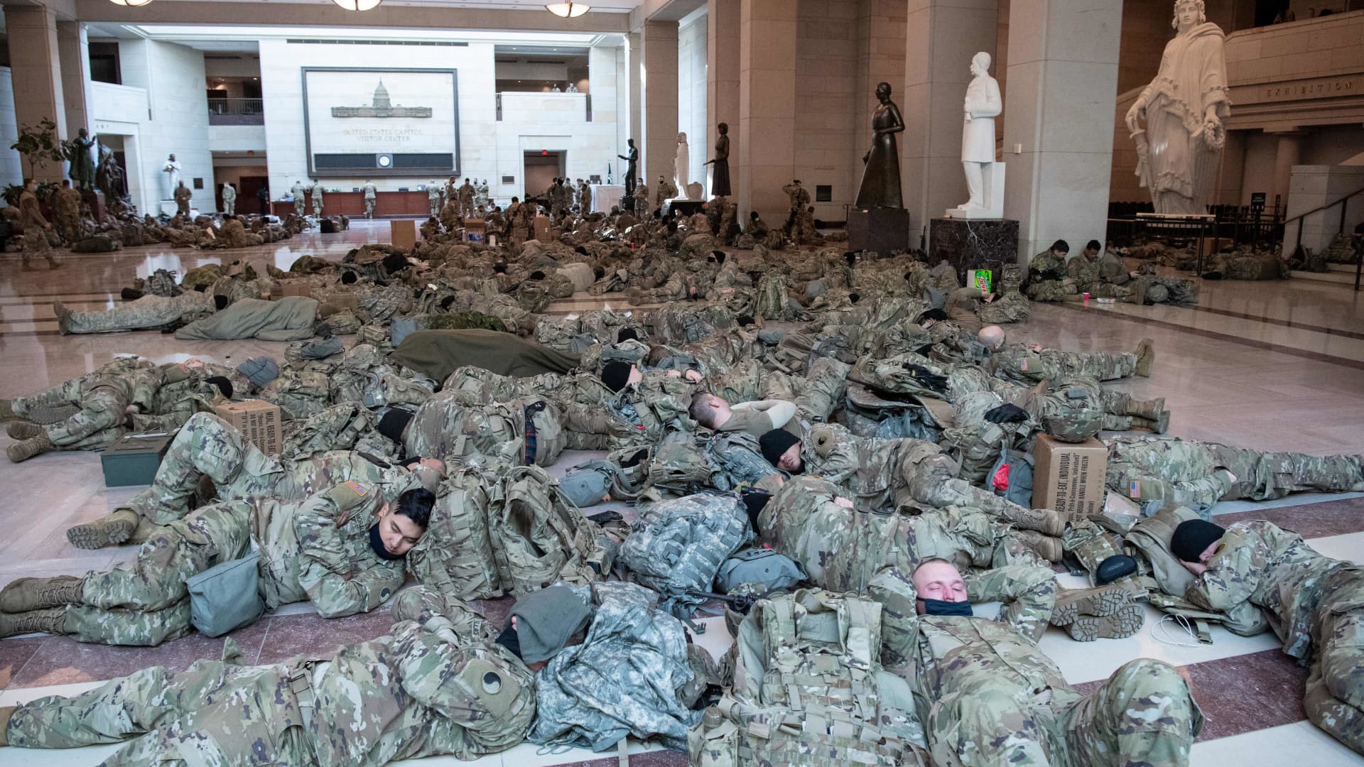 Members of the National Guard rest in the Capitol Visitors Center on Capitol Hill in Washington, DC, January 13, 2021, ahead of an expected House vote impeaching US President Donald Trump.