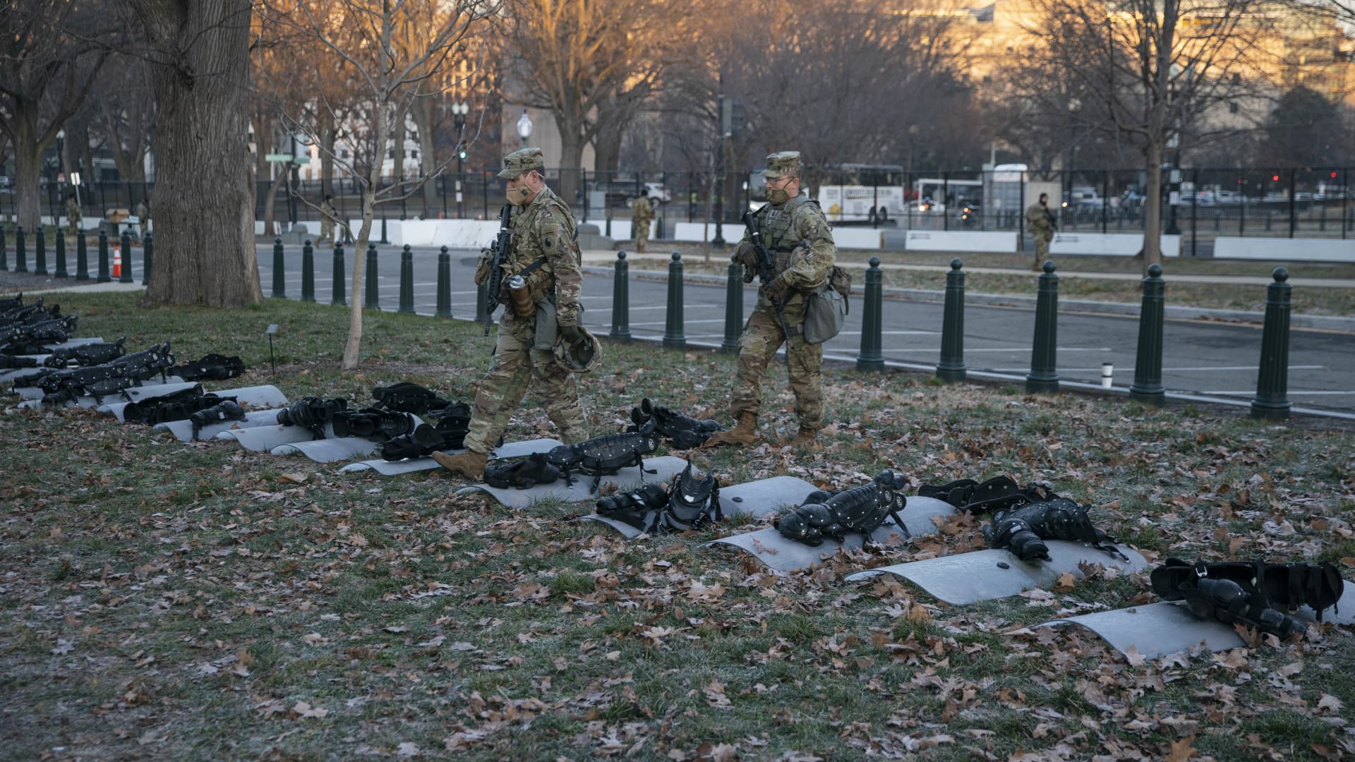 Members of the National Guard stand in front of riot shields and body armor on the lawn of the U.S. Capitol in Washington, D.C., U.S., on Wednesday, Jan. 13, 2021.