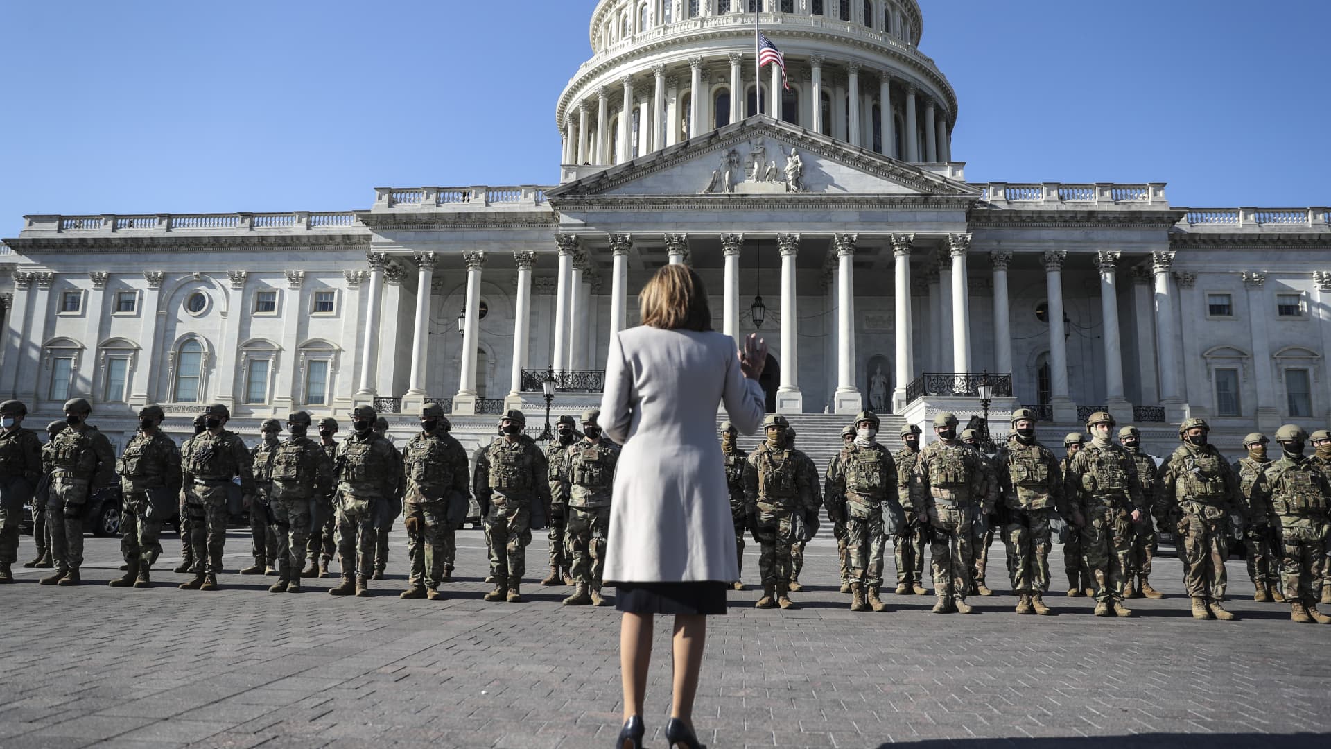 U.S. House Speaker Nancy Pelosi, D-Calif., stands in front of a National Guard troop as she speaks, on the East Entrance of the US Capitol in Washington, DC, on January 13, 2021.