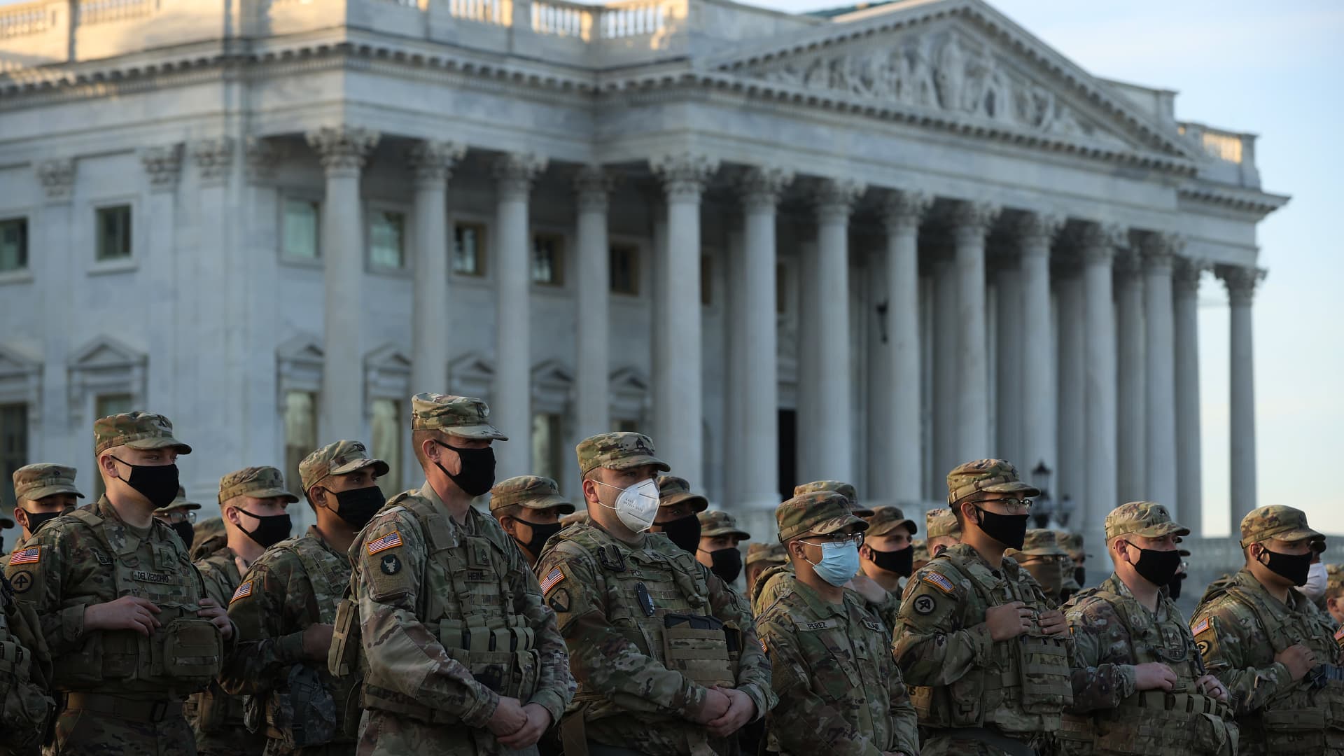 National Guard troops pose for photographers on the East Front of the U.S. Capitol the day after the House of Representatives voted to impeach President Donald Trump for the second time January 14, 2021 in Washington, DC.