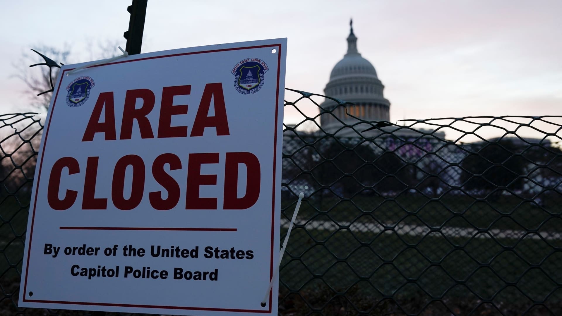 The Capitol is seen behind a fence and a sign, in Washington, U.S., January 15, 2021.