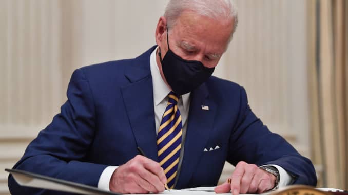 US President Joe Biden signs executive orders for economic relief to Covid-hit families and businesses in the State Dining Room of the White House in Washington, DC, on January 22, 2021.