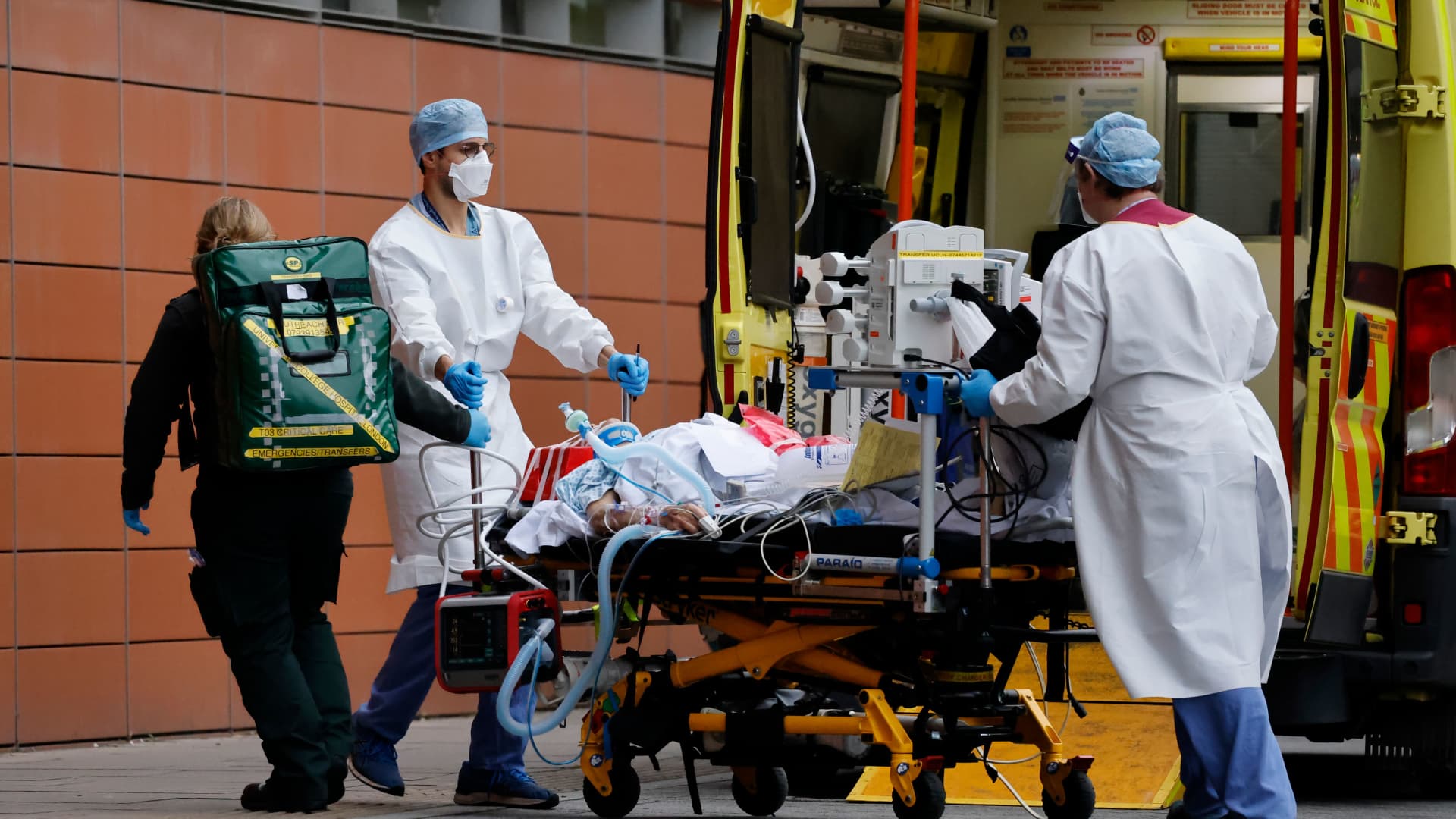 Medics take a patient from an ambulance into the Royal London hospital in London on January 19, 2021.