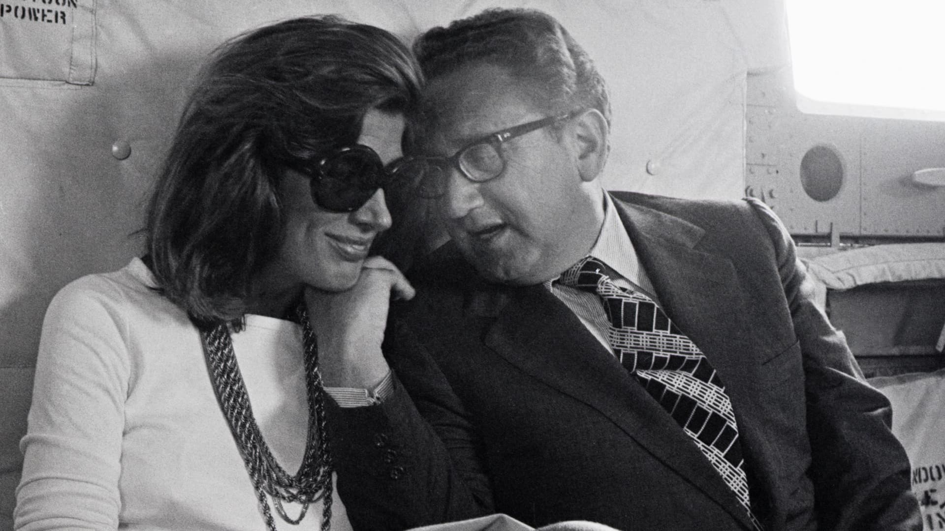 On a helicopter during the period of shuttle diplomacy in the Middle East, Henry Kissinger talks to his wife, Nancy.