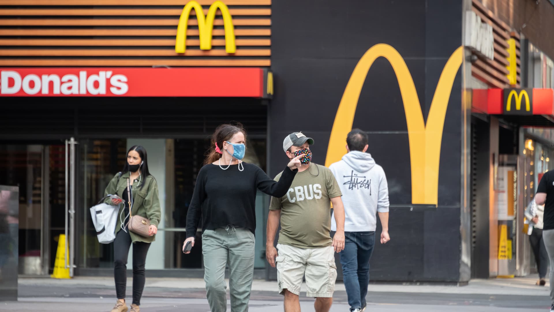 People wear protective face masks outside McDonald's in Times Square as the city continues Phase 4 of re-opening following restrictions imposed to slow the spread of coronavirus on September 18, 2020 in New York City.