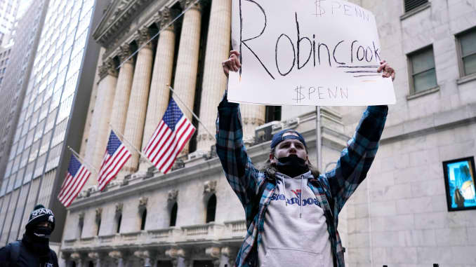 A demonstrator holds up a placard saying Robin Crook in front of the New York Stock Exchange, January 28, 2021.