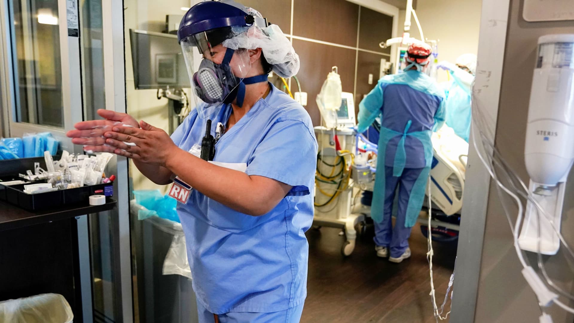 A nurse sanitizes her hands as she leaves a coronavirus disease (COVID-19) patients room in the ICU at SSM Health St. Anthony Hospital in Oklahoma City, Oklahoma, January 28, 2021.