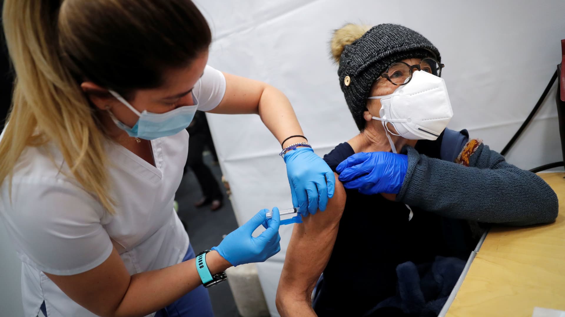 A healthcare worker administers a shot of the Moderna COVID-19 Vaccine to a woman at a pop-up vaccination site operated by SOMOS Community Care during the coronavirus disease (COVID-19) pandemic in New York, January 29, 2021.