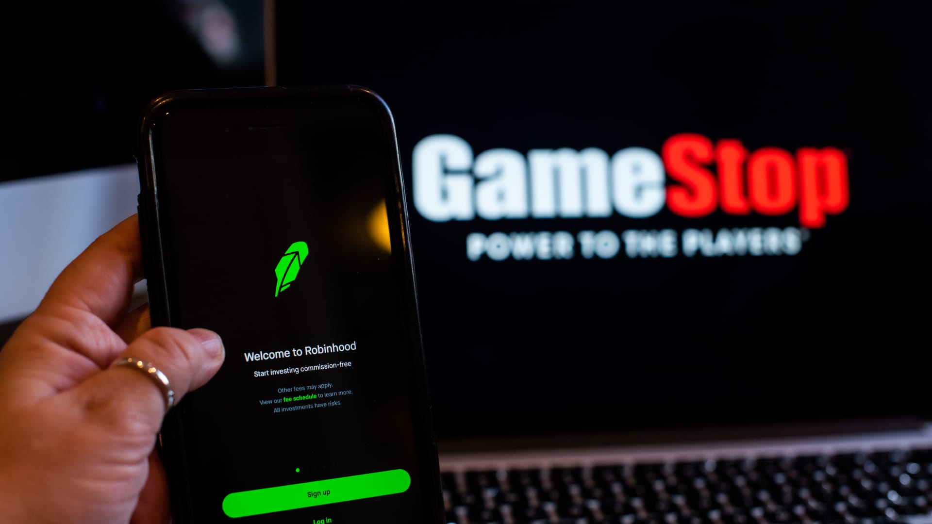 The GameStop Corp. logo on a laptop computer and Robinhood application on a smartphone.