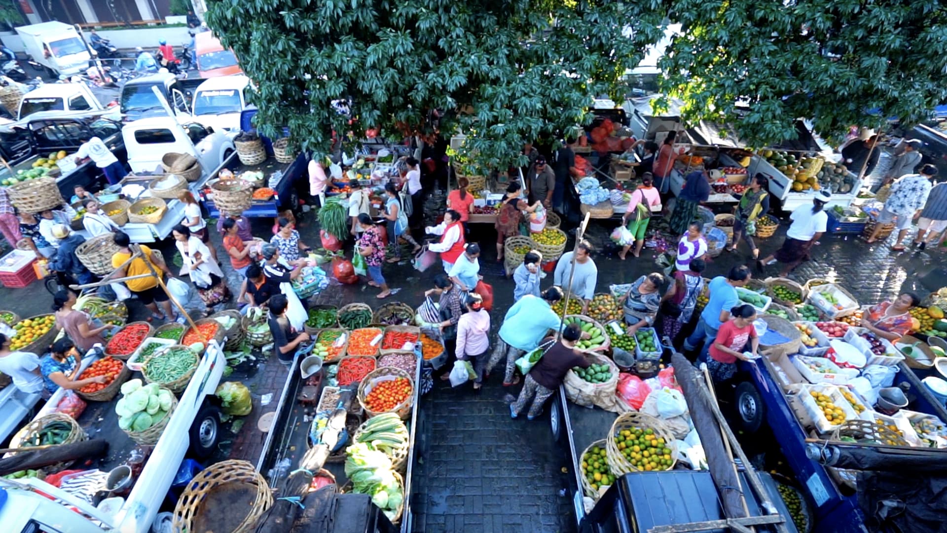 Street vendors sell fresh produce at an Indonesian market.