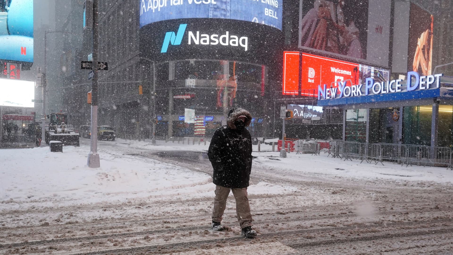 A person crosses a street during a snow storm, amid the coronavirus disease (COVID-19) pandemic, in the Manhattan borough of New York City, New York, U.S., February 1, 2021.