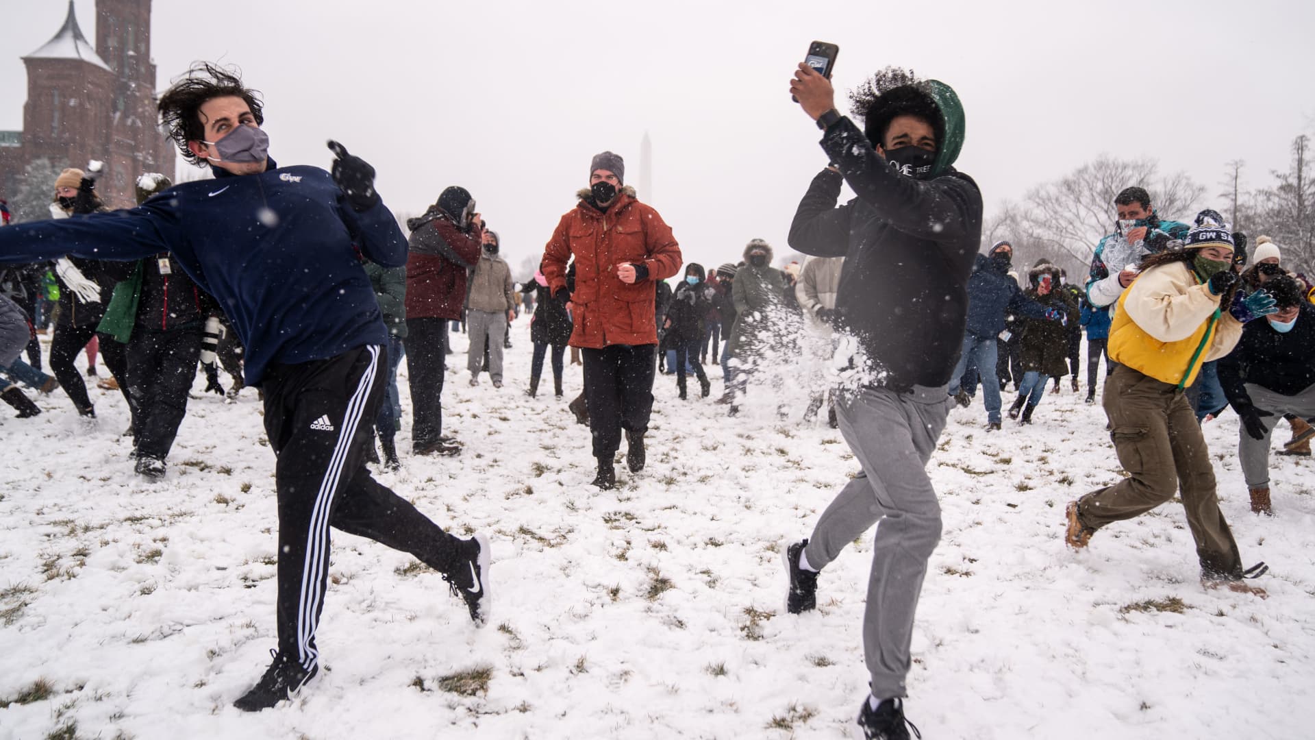 People take part in a snowball fight as snow blankets the National Mall on Sunday, Jan. 31, 2021 in Washington, DC.