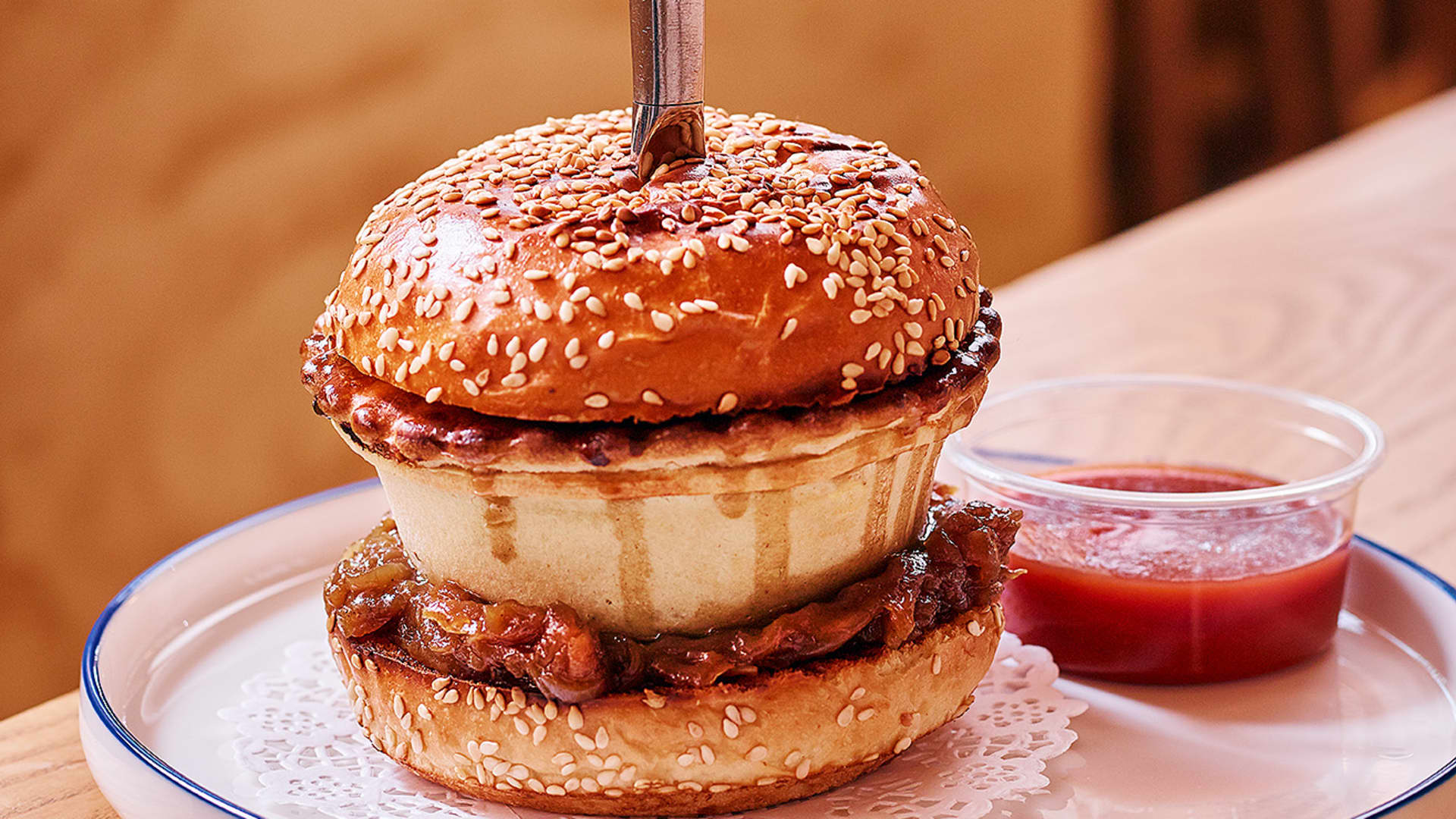 Not to be confused with a hamburger, Wonder Pies' Tradie Slammer is a beef pie served between two brioche buns, served with house-made chutney.