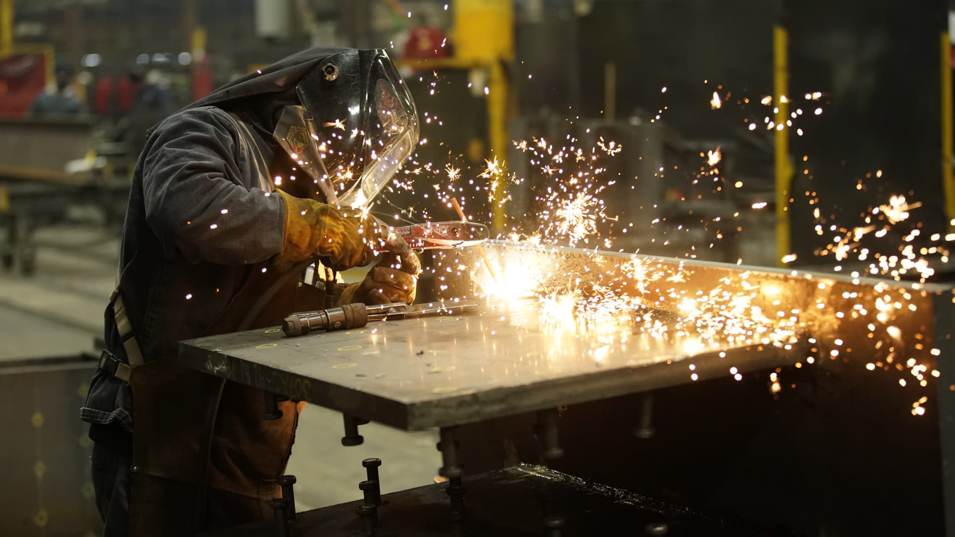 A worker welds a structural steel beam during production at the SME Steel Contractors facility in West Jordan, Utah, on Feb. 1, 2021.