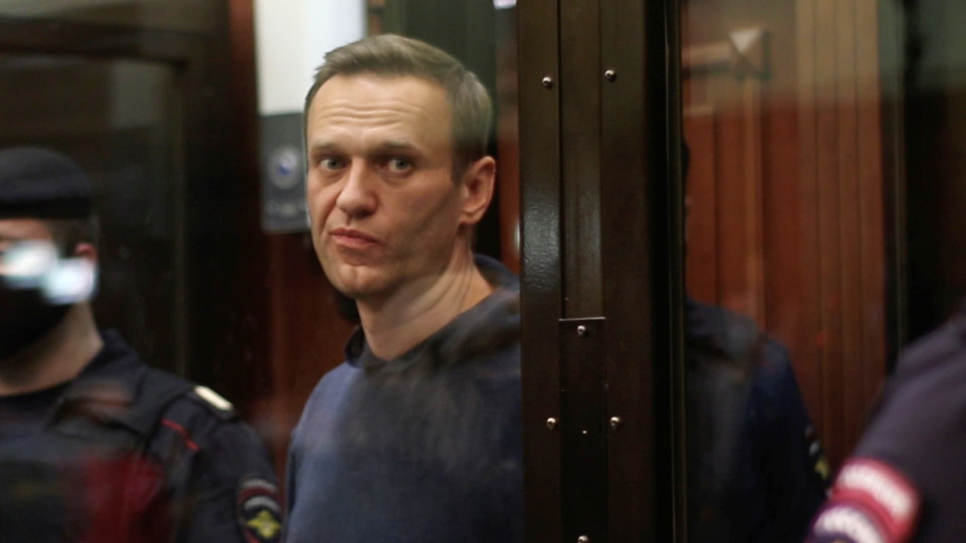 A still image taken from video footage shows Russian opposition leader Alexei Navalny, who is accused of flouting the terms of a suspended sentence for embezzlement, during the announcement of a court verdict in Moscow, Russia February 2, 2021.