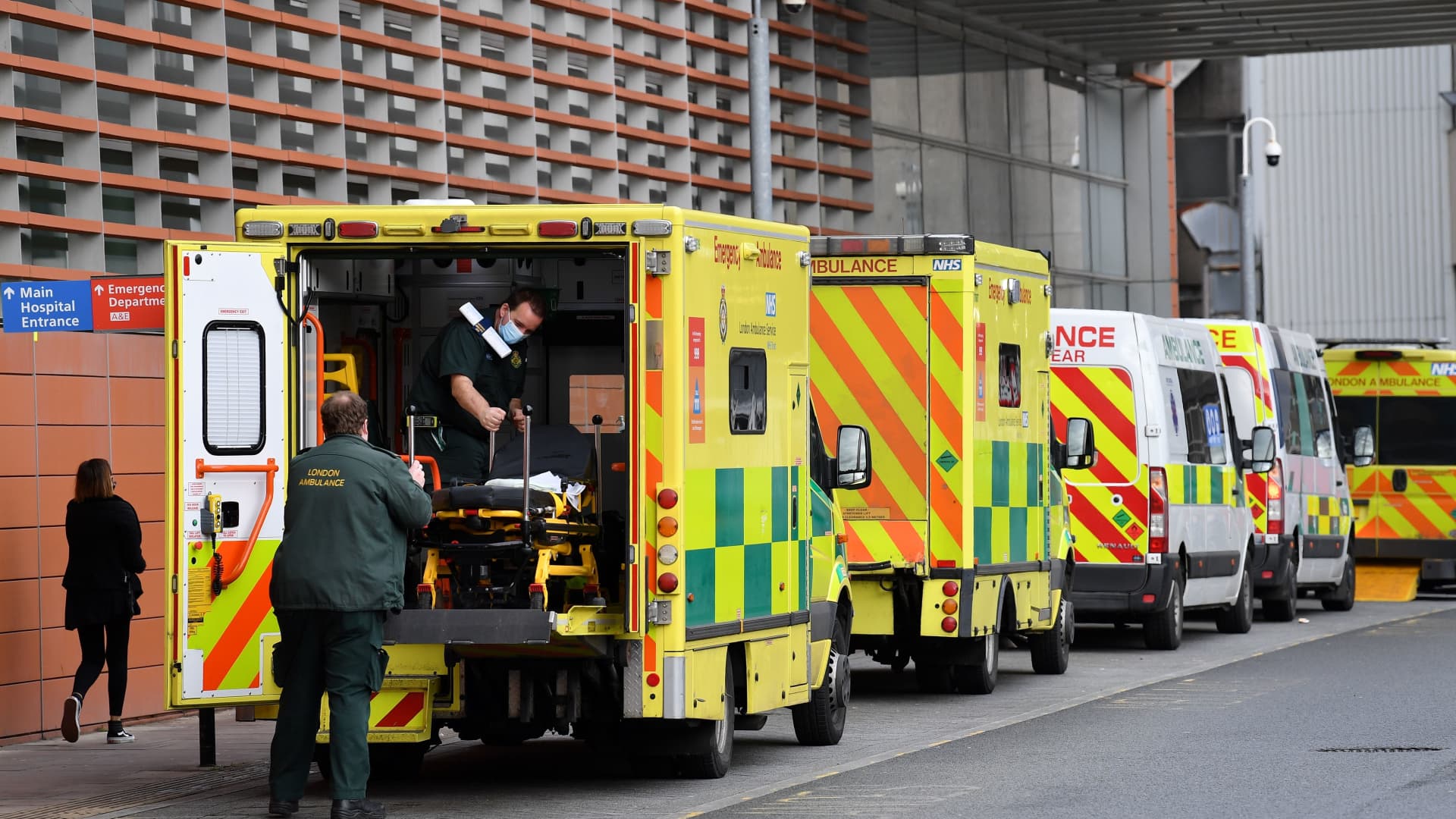 Paramedics move a patient from a ambulance to the Royal London Hospital in east London on January 28, 2021.