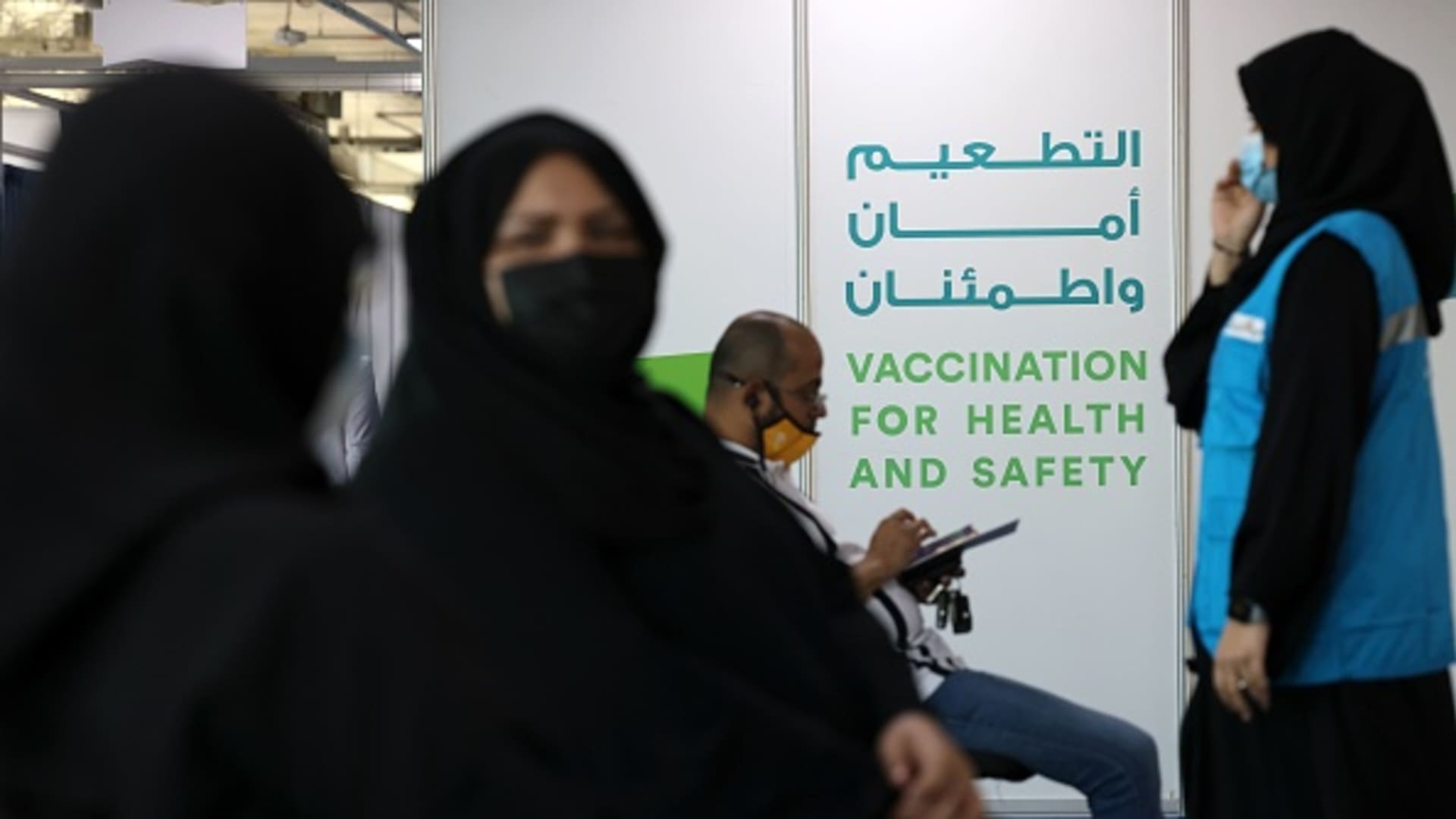 People wait their turn to get vaccinated against the coronavirus at a vaccination center set up at the Dubai International Financial Center in the Gulf emirate of Dubai, on February 3, 2021. The UAE has administered at least three million doses to more than a quarter of its population.