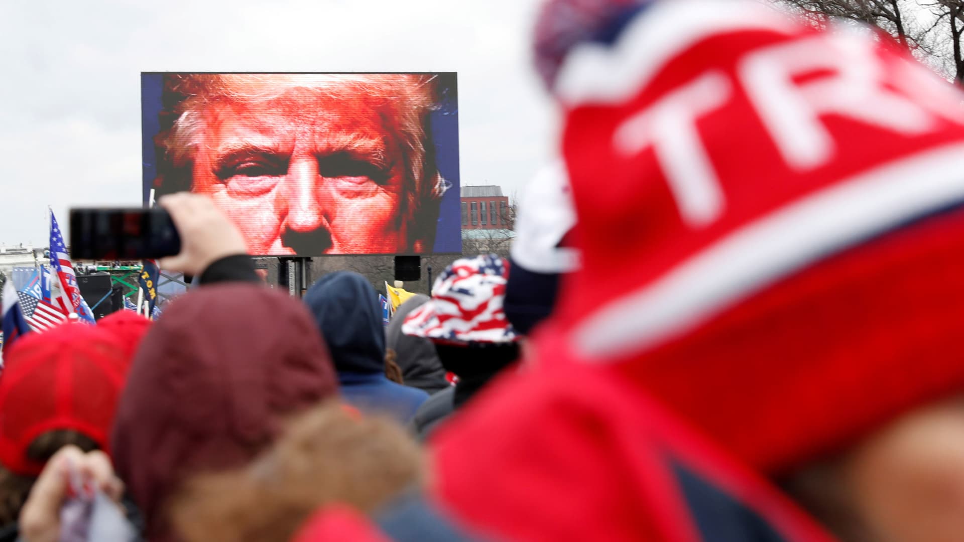President Donald Trump is seen on a screen speaking to supporters during a rally to contest the certification of the 2020 U.S. presidential election results by the U.S. Congress, in Washington, January 6, 2021.