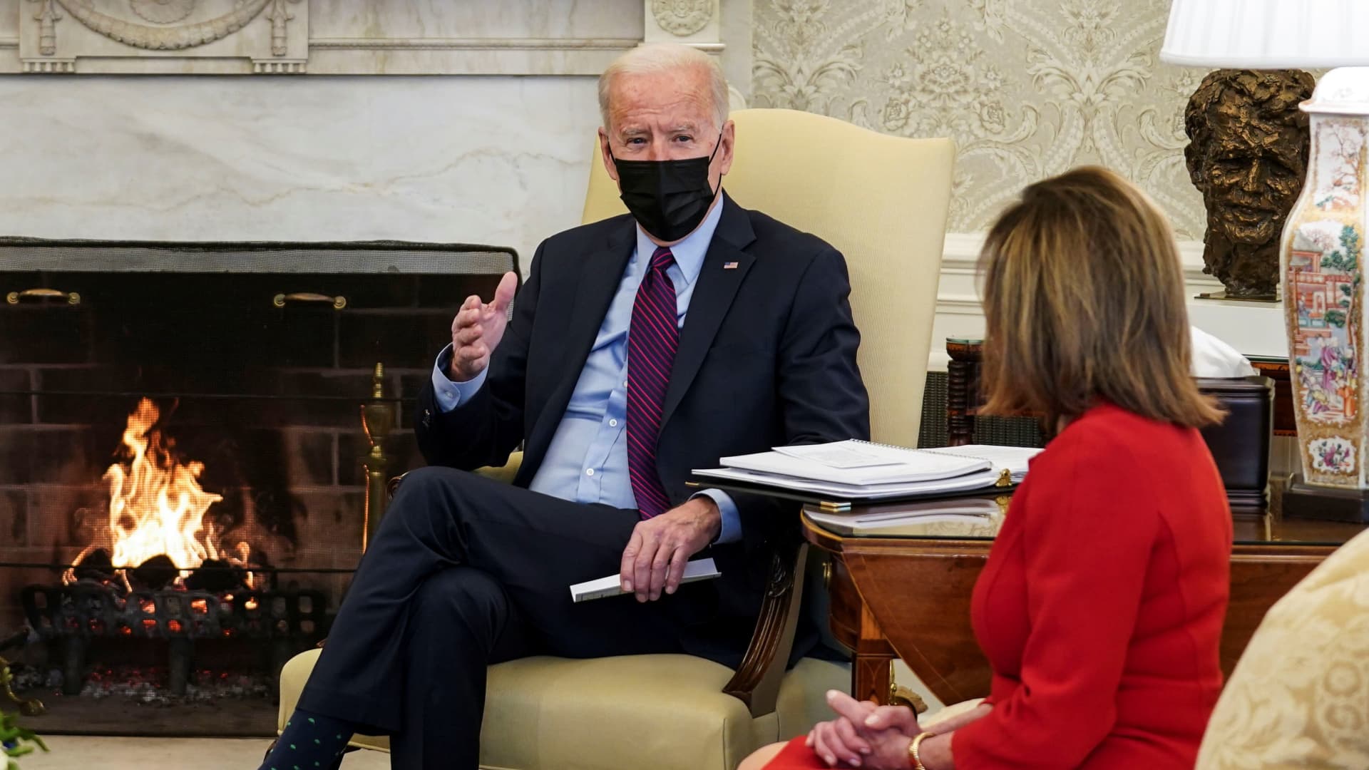President Joe Biden speaks with beside House Speaker Nancy Pelosi (D-CA) during a meeting with Democratic leaders and chairs of House committees working on coronavirus disease (COVID-19) aid legislation, in the Oval Office at the White House in Washington, February 5, 2021.