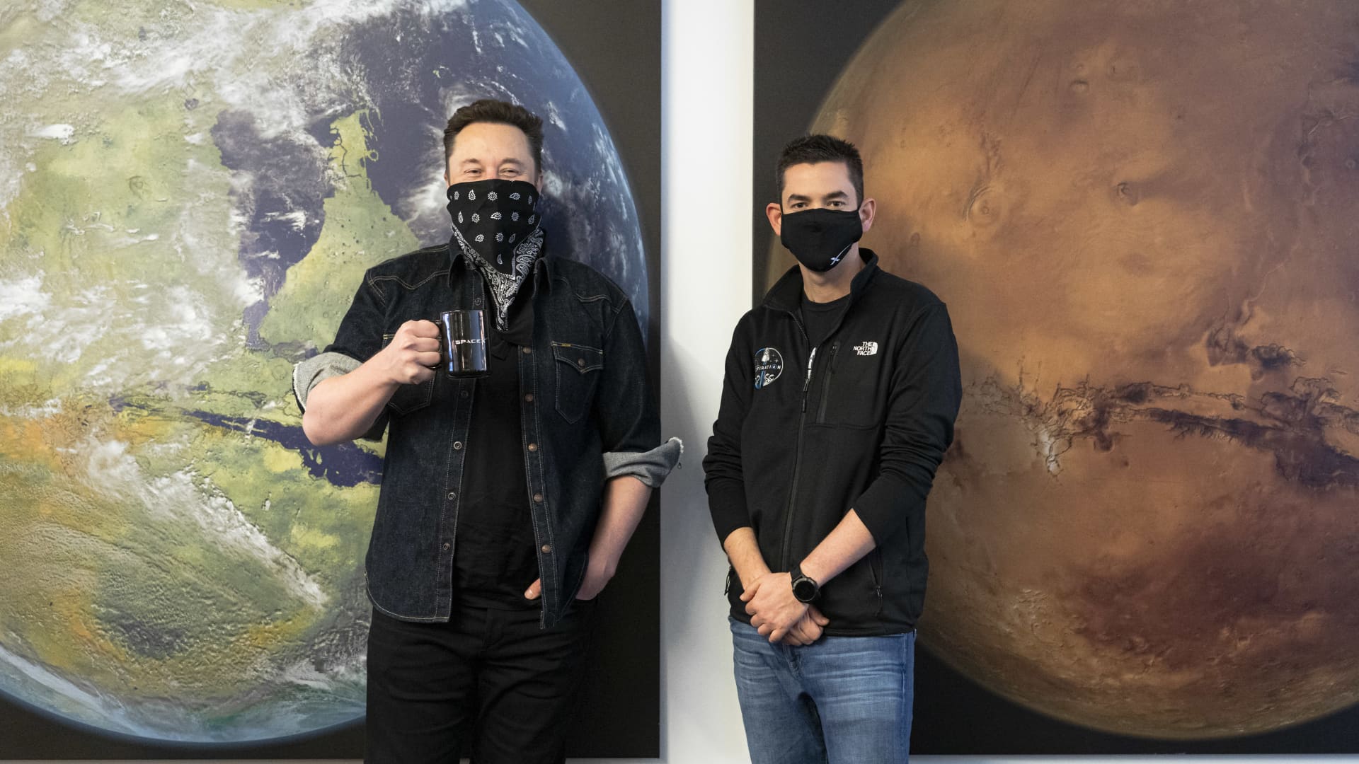 SpaceX CEO Elon Musk and Shift4 Payments CEO Jared Isaacman pose together at SpaceX headquarters in Hawthorne, California to announce the Inspiration4 all-civilian space mission.