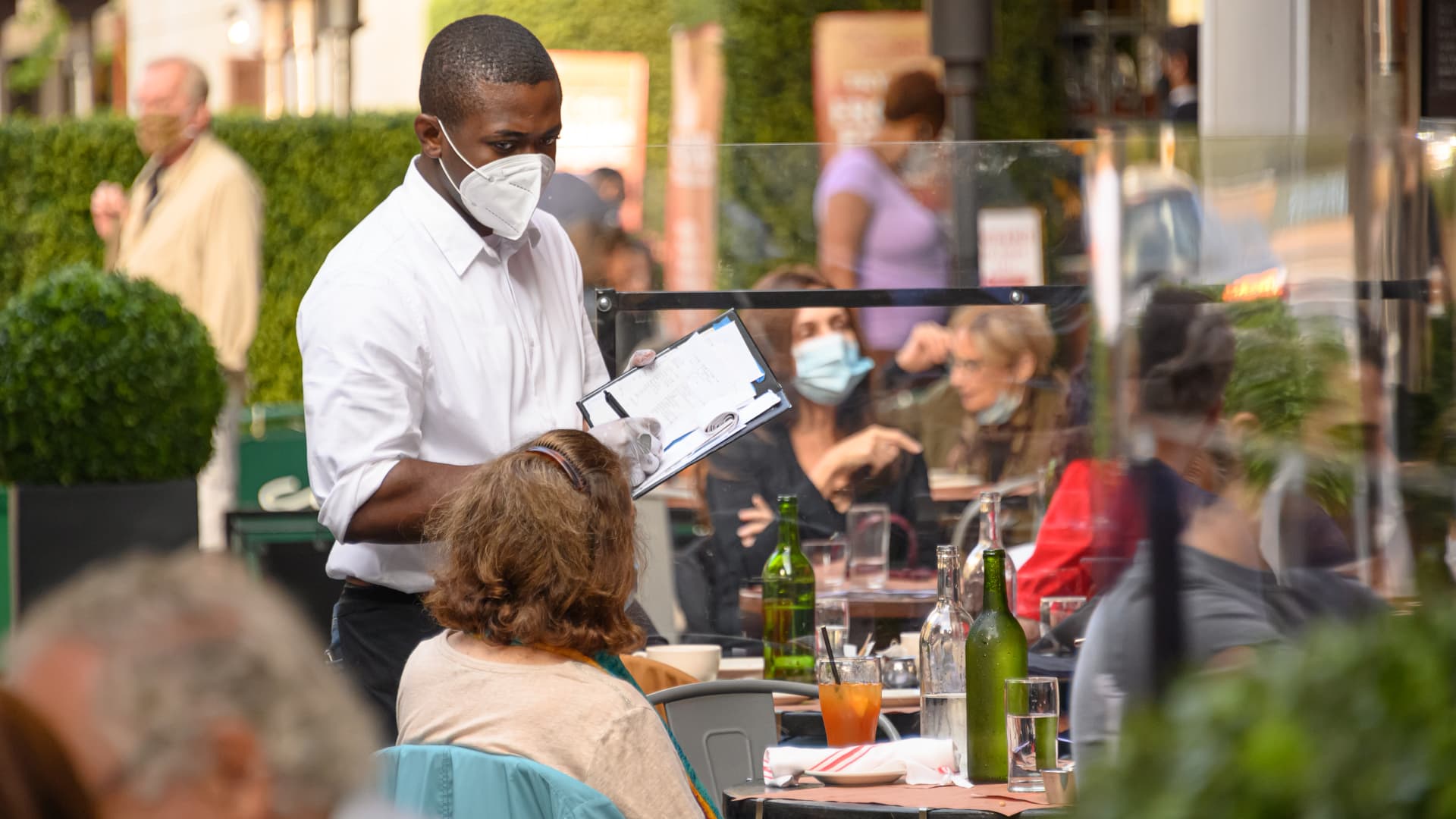 A New York City waiter wears a face mask at a restaurant on Manhattan's Upper West Side on Nov. 10, 2020.