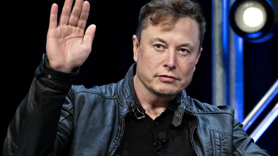 Elon Musk, founder of SpaceX and chief executive officer of Tesla Inc., waves while arriving to a discussion at the Satellite 2020 Conference in Washington, D.C., U.S., on Monday, March 9, 2020.