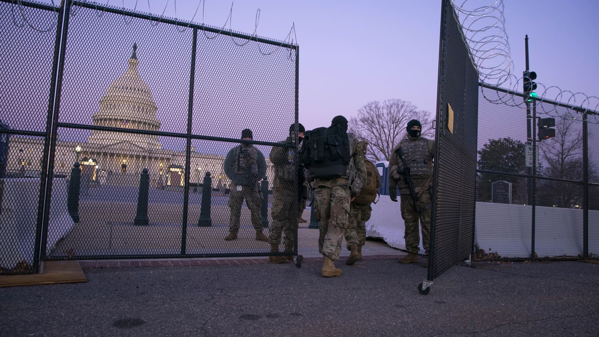 Members of the National Guard enter a gate of barbed wire fencing on U.S. Capitol grounds at sunrise on February 8, 2021 in Washington, DC. The Senate is scheduled to begin the second impeachment trial of former U.S. President Donald J. Trump on February 9.