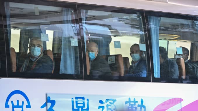 Members of the World Health Organization (WHO) team investigating the origins of the Covid-19 coronavirus pandemic leave The Jade Hotel on a bus after completing their quarantine in Wuhan, Chinas central Hubei province on January 28, 2021.