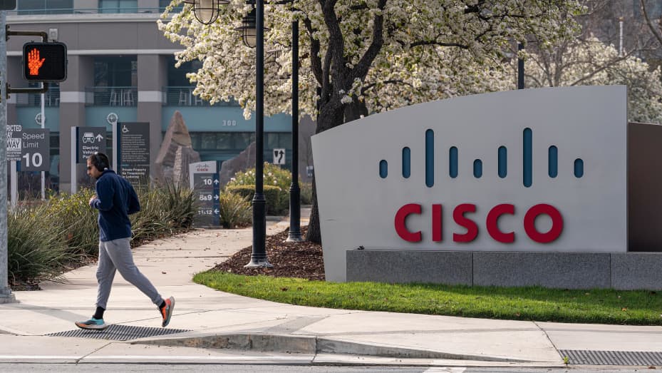 A runner jogs past Cisco Systems headquarters in San Jose, California, U.S., on Monday, Feb. 8, 2021.