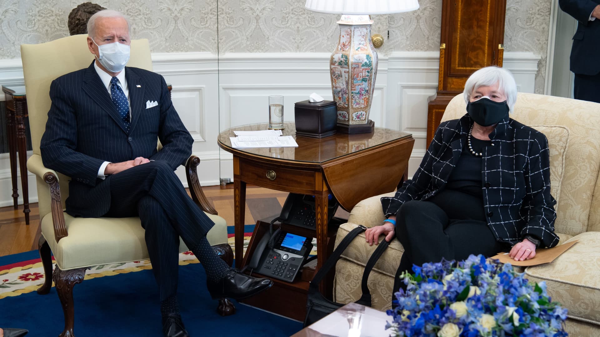 President Joe Biden sits alongside US Treasury Secretary Janet Yellen (R) as he holds a meeting with business leaders about a Covid relief bill in the Oval Office of the White House in Washington, DC, February 9, 2021.