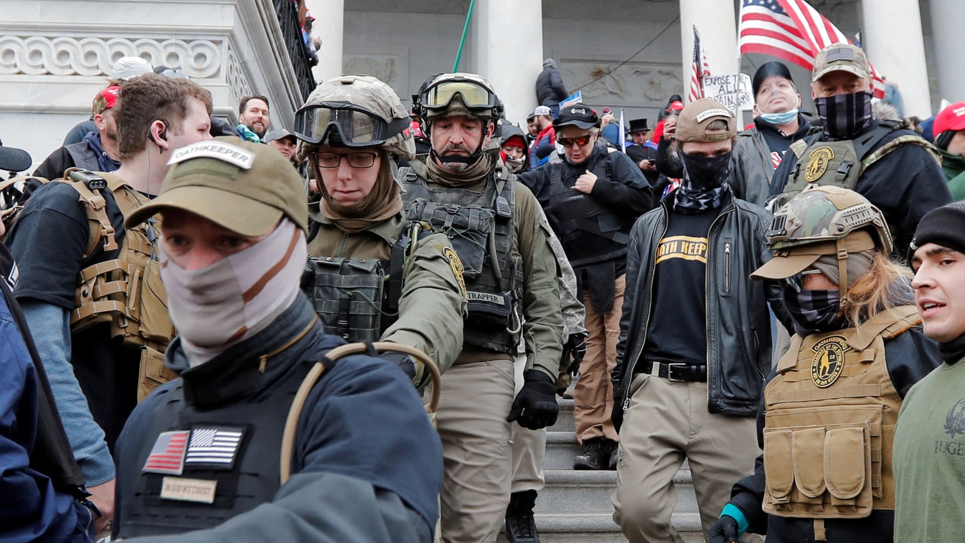 Jessica Marie Watkins (2nd from L) and Donovan Ray Crowl (Center), both from Ohio, march down the east front steps of the U.S. Capitol with the Oath Keepers militia group among supporters of U.S. President Donald Trump in Washington, January 6, 2021. Both have since been indicted by federal authorities for their roles in the siege on the U.S. Capitol.