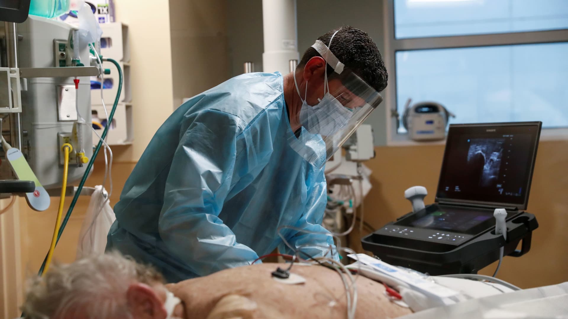A critical care respiratory therapist works with a coronavirus disease (COVID-19) positive patient in the intensive care unit (ICU) at Sarasota Memorial Hospital in Sarasota, Florida, February 11, 2021.