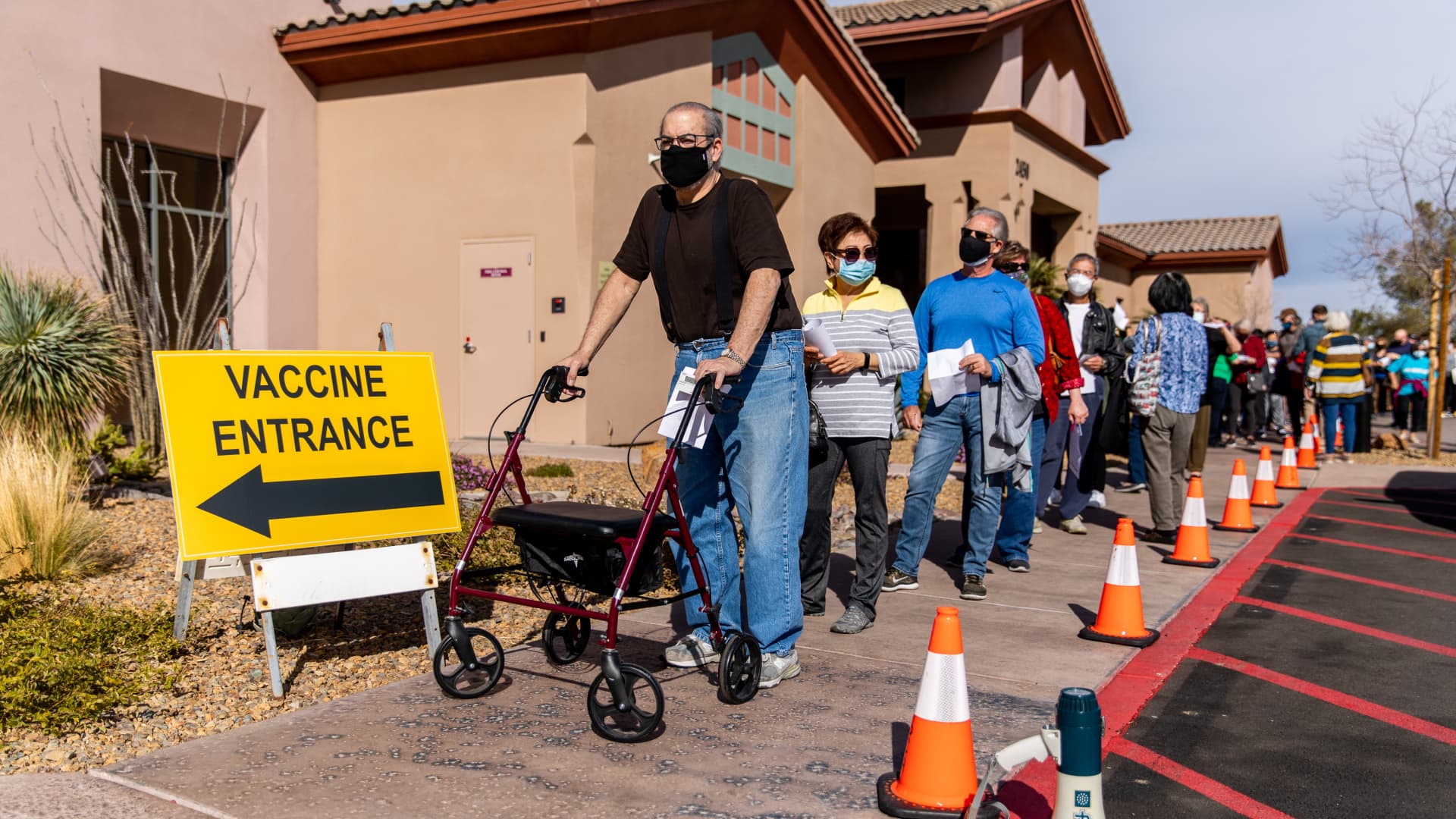 People without appointments stand in line to possibly receive a dose of the Pfizer-BioNTech Covid-19 vaccine after all appointments have been administered at the Sun City Anthem Community Center vaccination site in Henderson, Nevada, on Thursday, Feb. 11, 2021.
