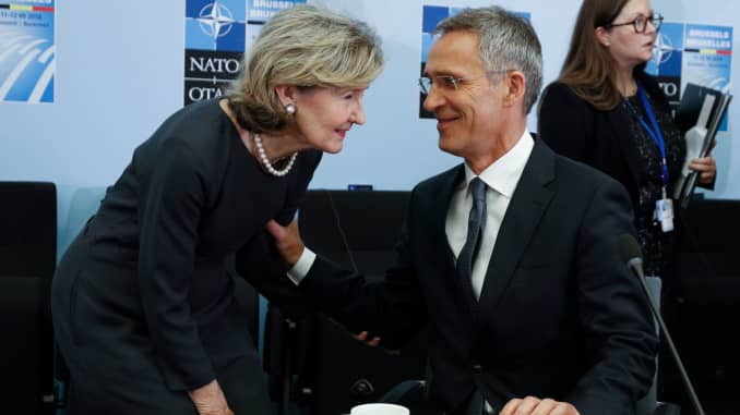 NATO Secretary General Jens Stoltenberg greets NATO's US Ambassador Kay Bailey Hutchison on the second day of the NATO summit, in Brussels, on July 12, 2018.