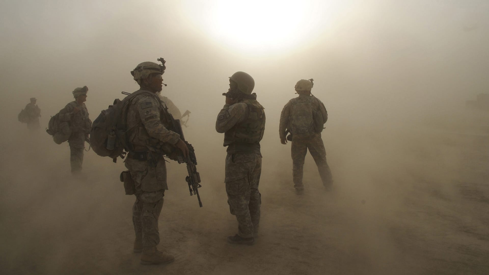 1st Battalion, 501st Infantry Regiment, 4th Brigade Combat Team, 25th Infantry Division, watch as CH-47 Chinook helicopters circle above during a dust storm at Forward Operating Base Kushamond, Afghanistan, July 17, during preparation for an air assault mission.