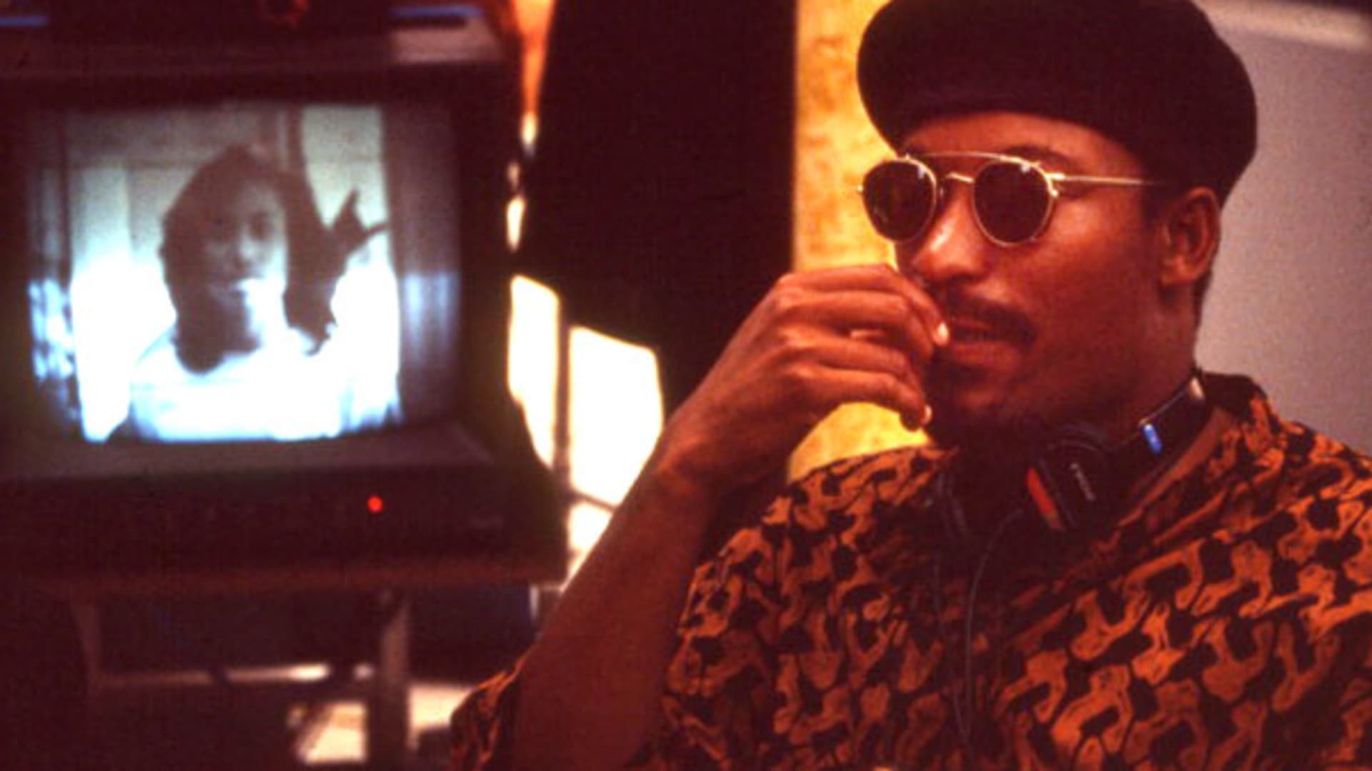 View of director John Singleton, wearing sunglasses and beret, while on the set of his movie 'Poetic Justice', Los Angeles, CA, 1993.