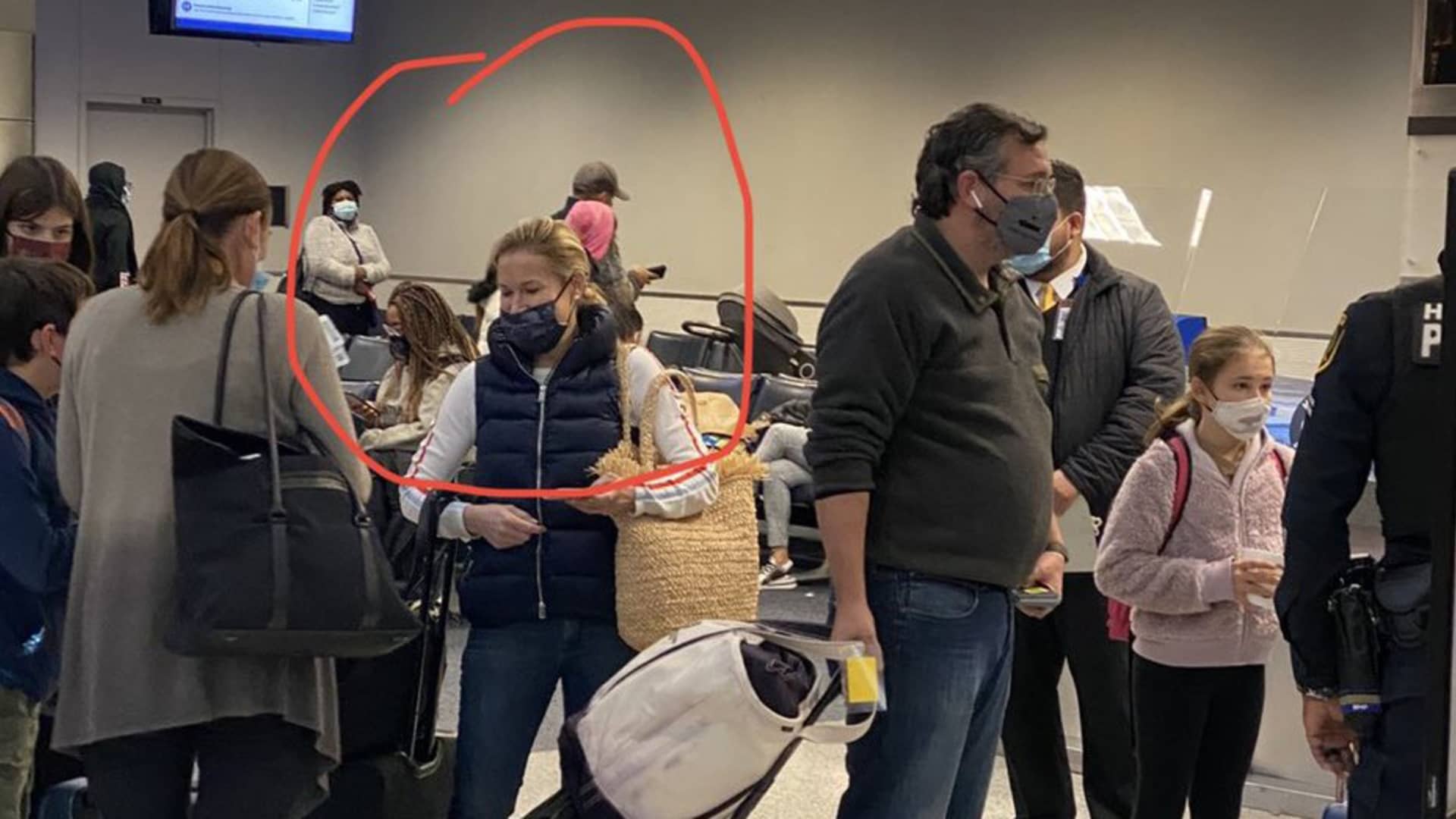 Images purportedly showing Ted Cruz with Heidi Cruz (circled) board a United Airlines Flight to Cancun, Mexico from Houston, TX.