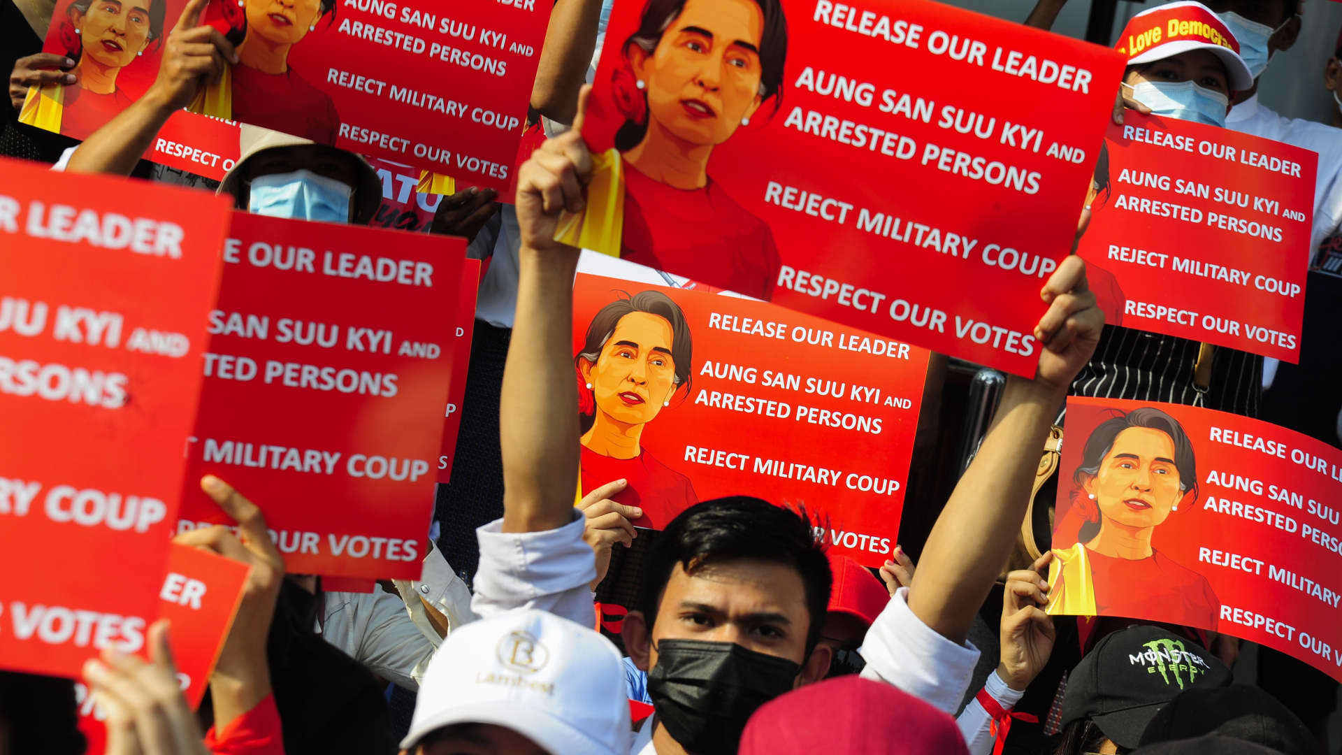 Anti-coup protesters hold placards as they protest against the military coup Saturday, February 20, 2021, in Yangon, Myanmar.