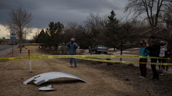 Residents take pictures of debris fallen from a United Airlines airplane's engine on the neighborhood of Broomfield, outside Denver, Colorado, on Feb. 20, 2021. A United Airlines flight suffered a fiery engine failure Feb. 20, shortly after taking off from Denver on its way to Hawaii, dropping massive debris on a residential area before a safe emergency landing, officials said.